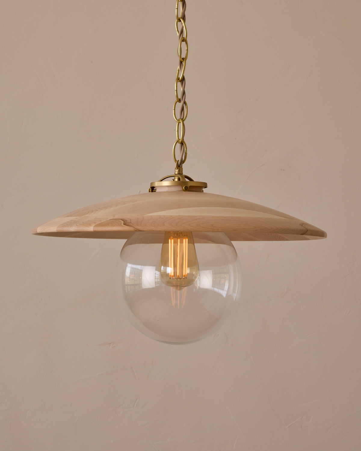 Large pendant light with oversized clear glass globe and decorative wooden clear maple shade with brass chain #shade-finish_clear maple #globe_clear glass #cord-color_beige
