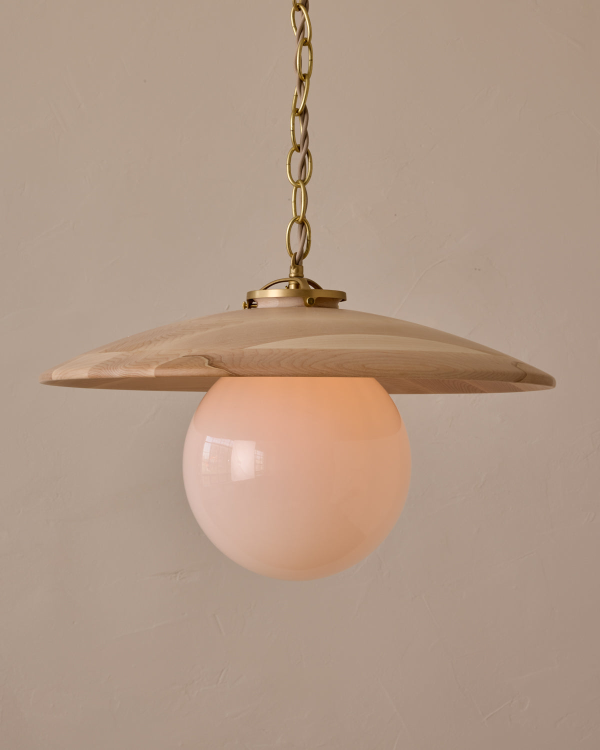 Large pendant light with oversized milk glass globe and decorative wooden clear maple shade with brass chain #shade-finish_clear maple #globe_white glass #cord-color_beige
