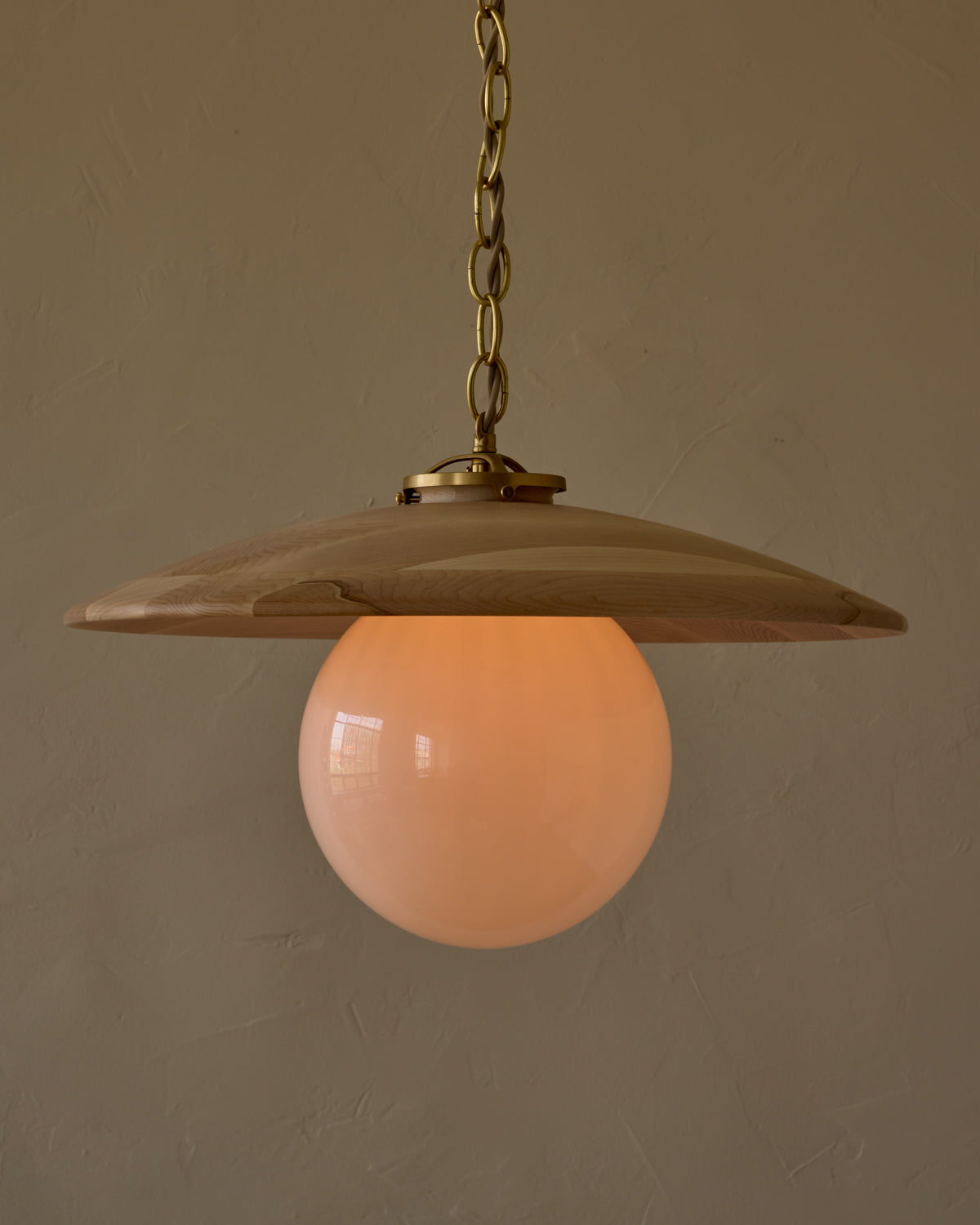 Large pendant light with oversized milk glass globe and decorative wooden clear maple shade with brass chain #shade-finish_clear maple #globe_white glass #cord-color_beige
