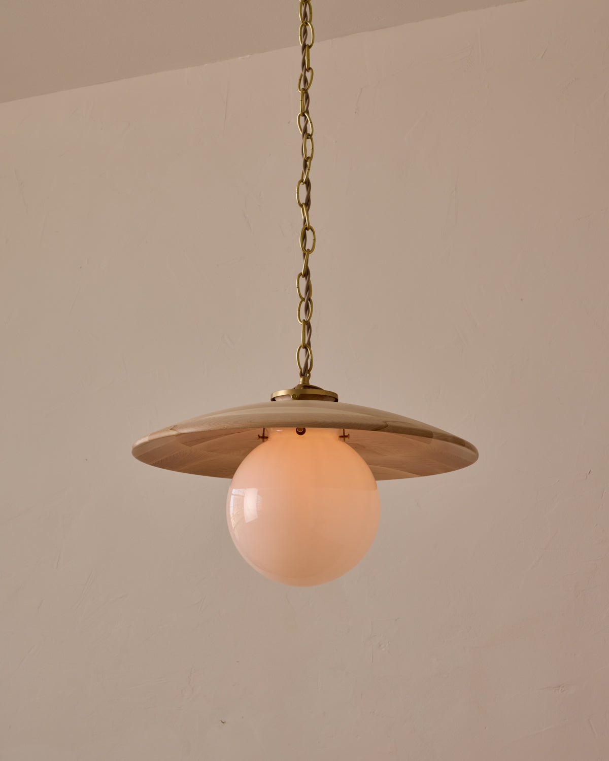 Large pendant light with oversized milk glass globe and decorative wooden clear maple shade with brass chain #shade-finish_clear maple #globe_white glass #cord-color_beige