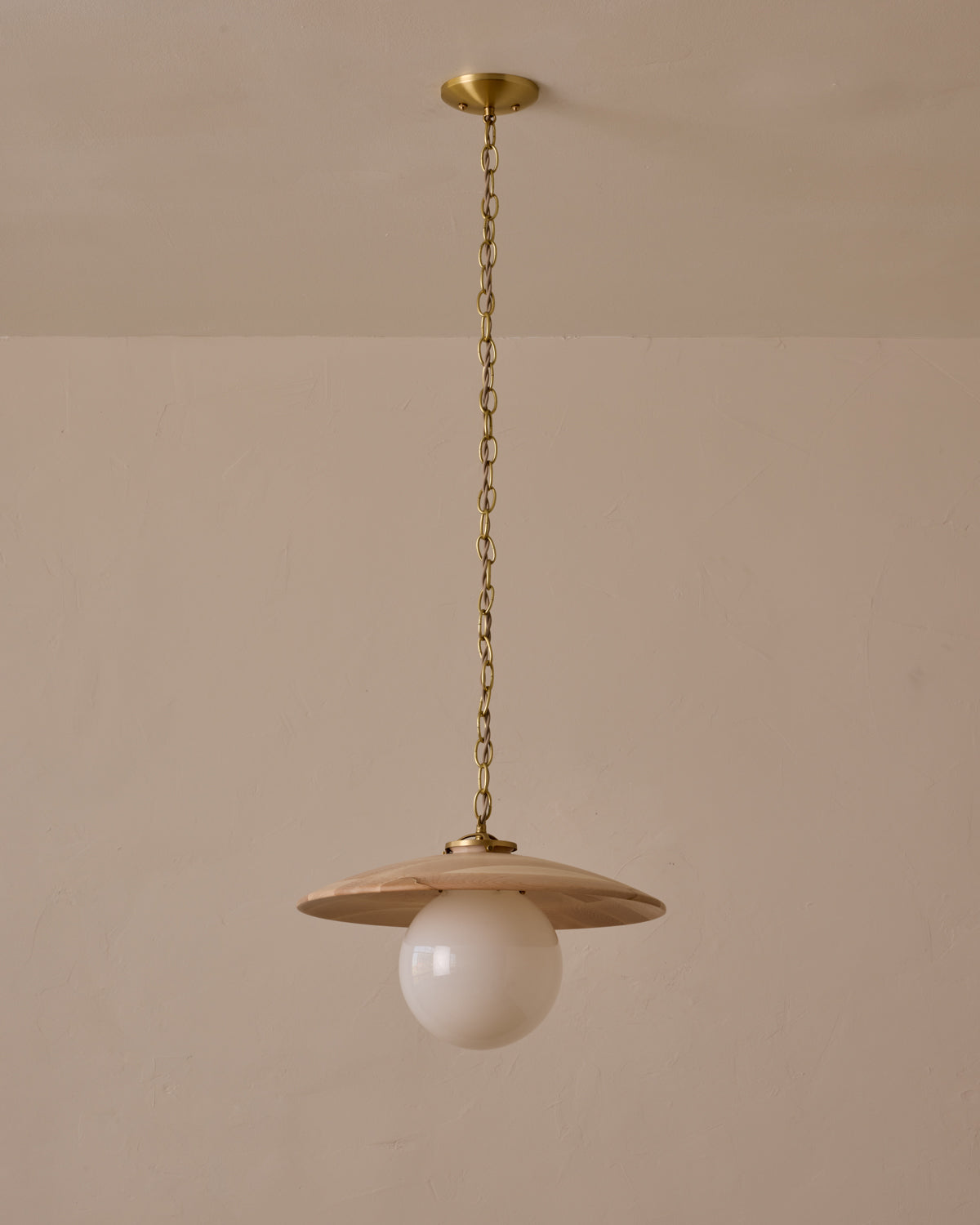 Large pendant light with oversized milk glass globe and decorative wooden clear maple shade with brass chain #shade-finish_clear maple #globe_white glass #cord-color_beige