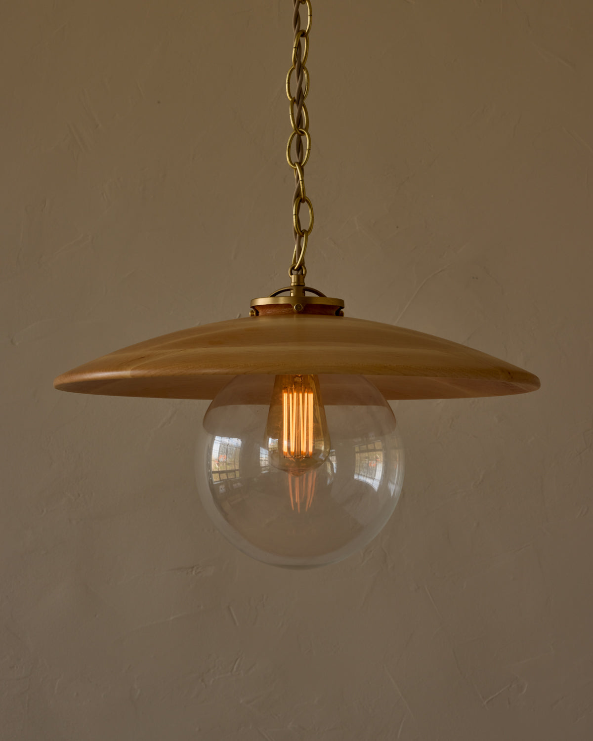 Large pendant light with oversized clear glass globe and decorative wooden clear maple shade with brass chain #shade-finish_natural maple #globe_clear glass #cord-color_beige