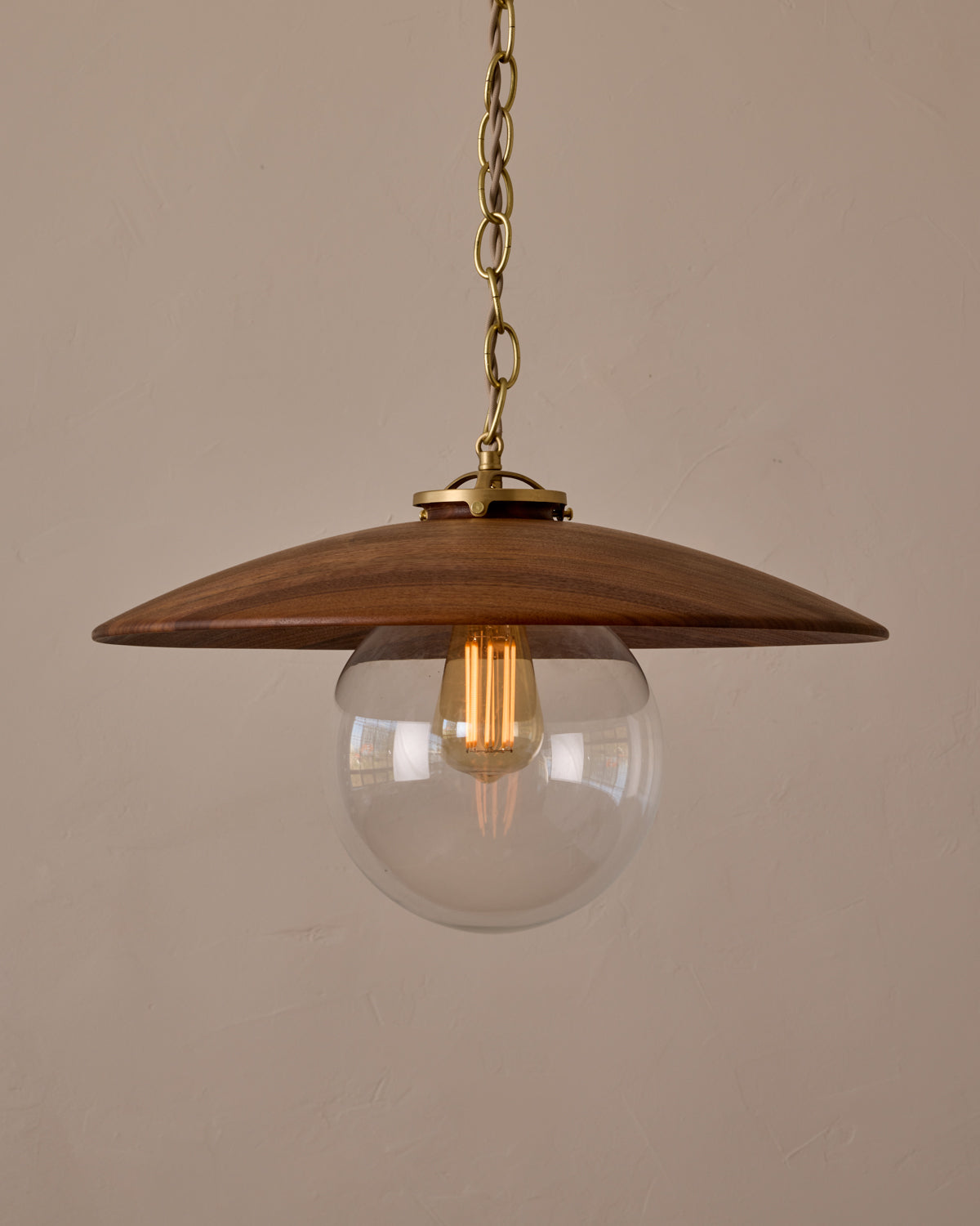 Large pendant light with oversized clear glass globe and decorative wooden clear maple shade with brass chain #shade-finish_black walnut #globe_clear glass #cord-color_beige