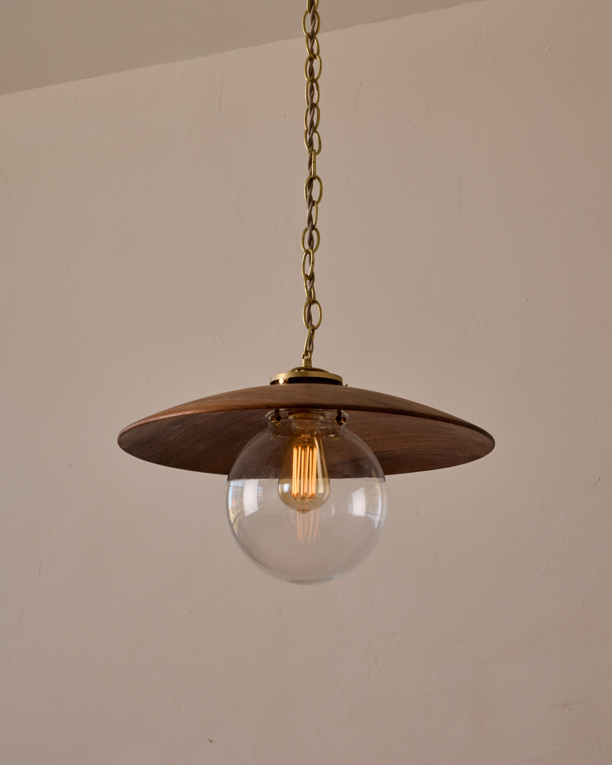 Large pendant light with oversized clear glass globe and decorative wooden clear maple shade with brass chain #shade-finish_black walnut #globe_clear glass #cord-color_beige