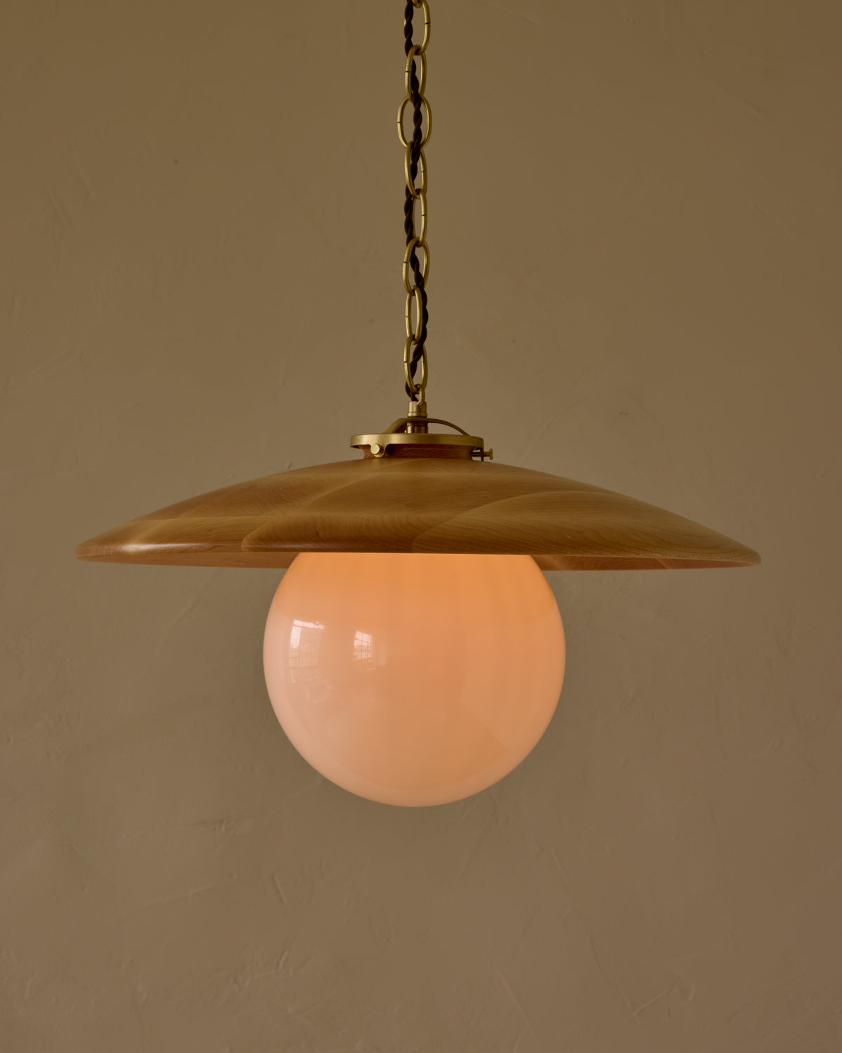 Large pendant light with oversized clear glass globe and decorative wooden clear maple shade with brass chain #shade-finish_natural maple #globe_white glass #cord-color_brown