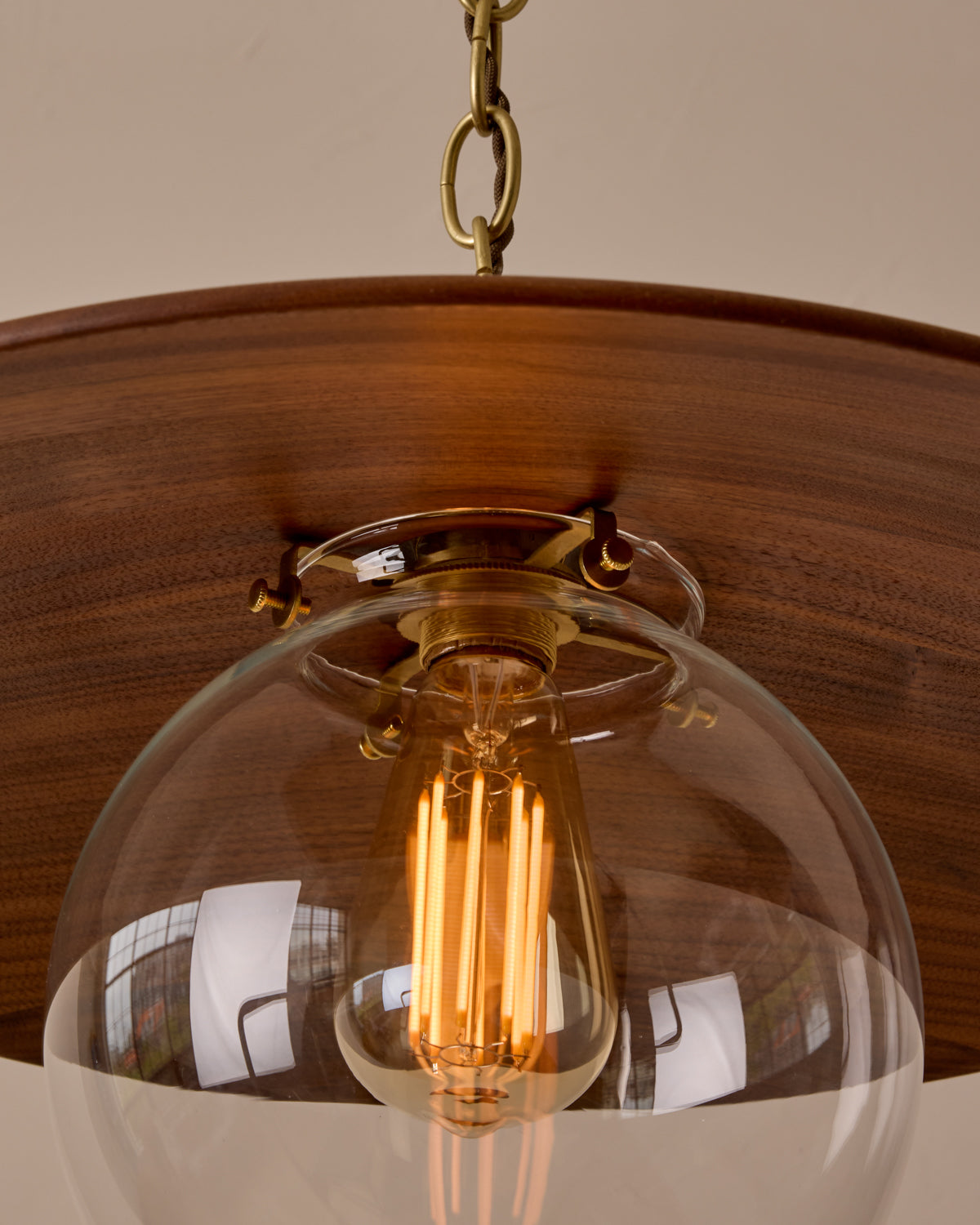 Large pendant light with oversized clear glass globe and decorative wooden clear maple shade with brass chain #shade-finish_black walnut #globe_clear glass #cord-color_brown
