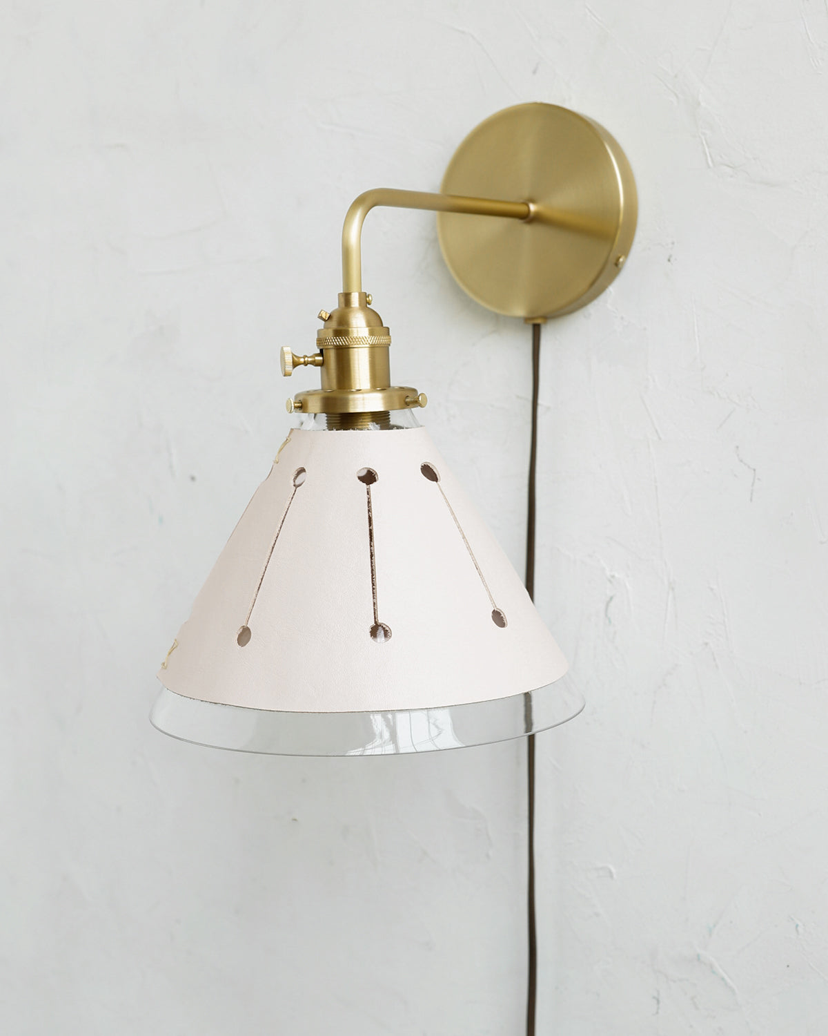 Classic satin brass plug in wall sconce with cone glass diffuser and decorative handstitched leather shade #leather-finish_dogwood #wiring_plug-in