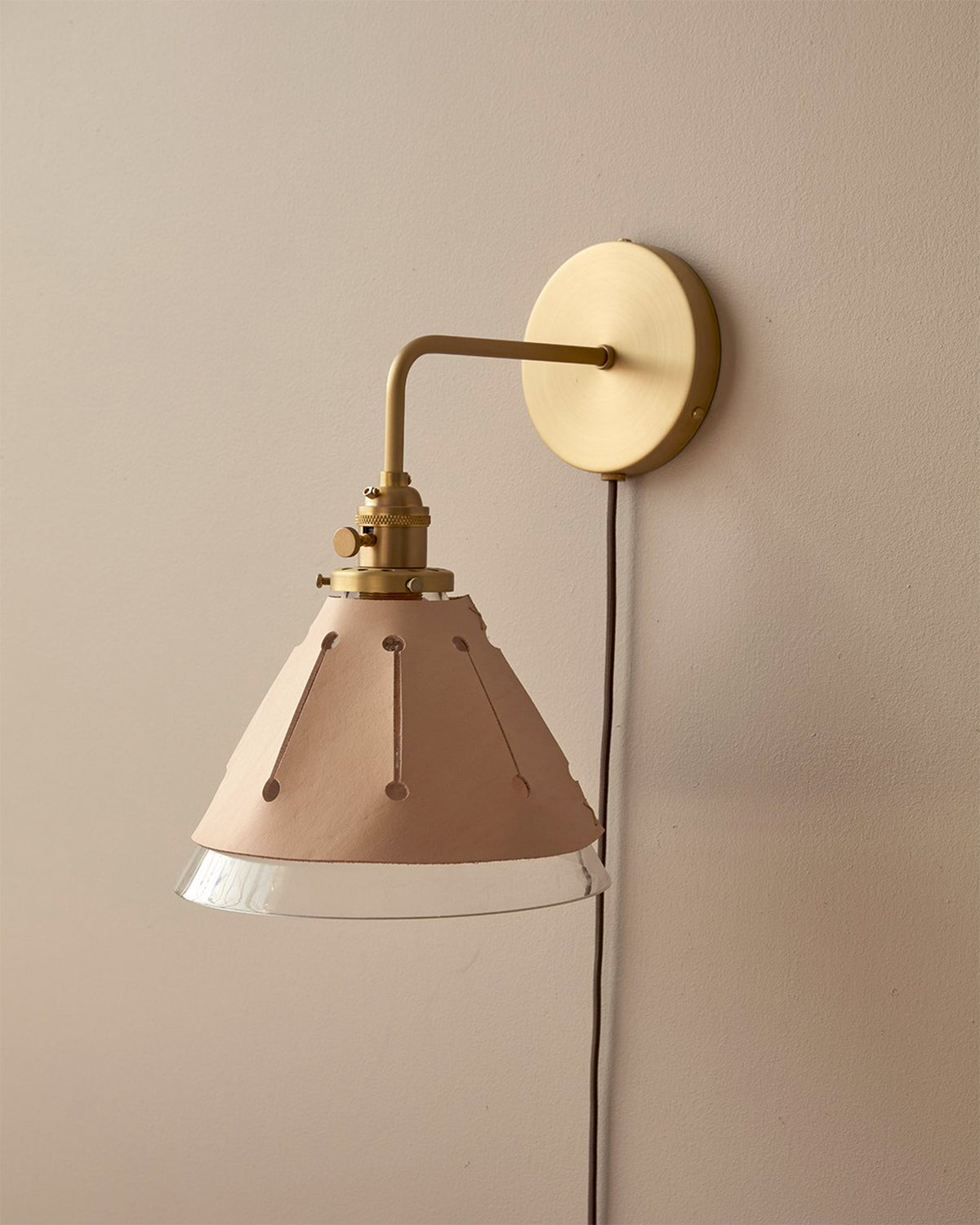 Classic satin brass plug in wall sconce with cone glass diffuser and decorative handstitched leather shade #leather-finish_natural tan #wiring_plug-in