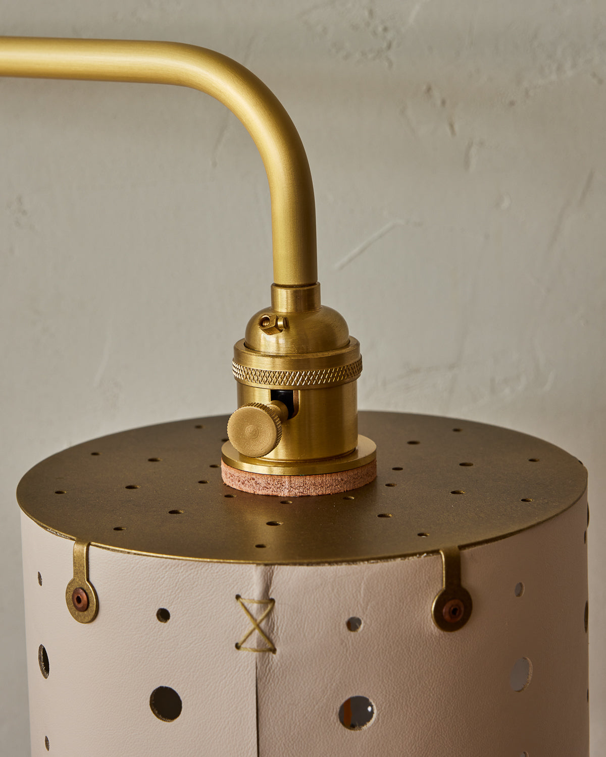 Articulating satin brass plug-in wall sconce with white handstitched shade and walnut backplate #leather-finish_dogwood