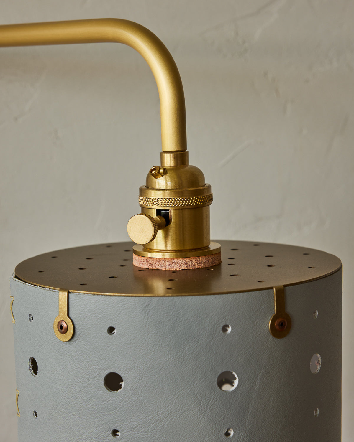 Articulating satin brass sconce with blue handstitched shade and walnut backplate #leather-finish_cloud blue
