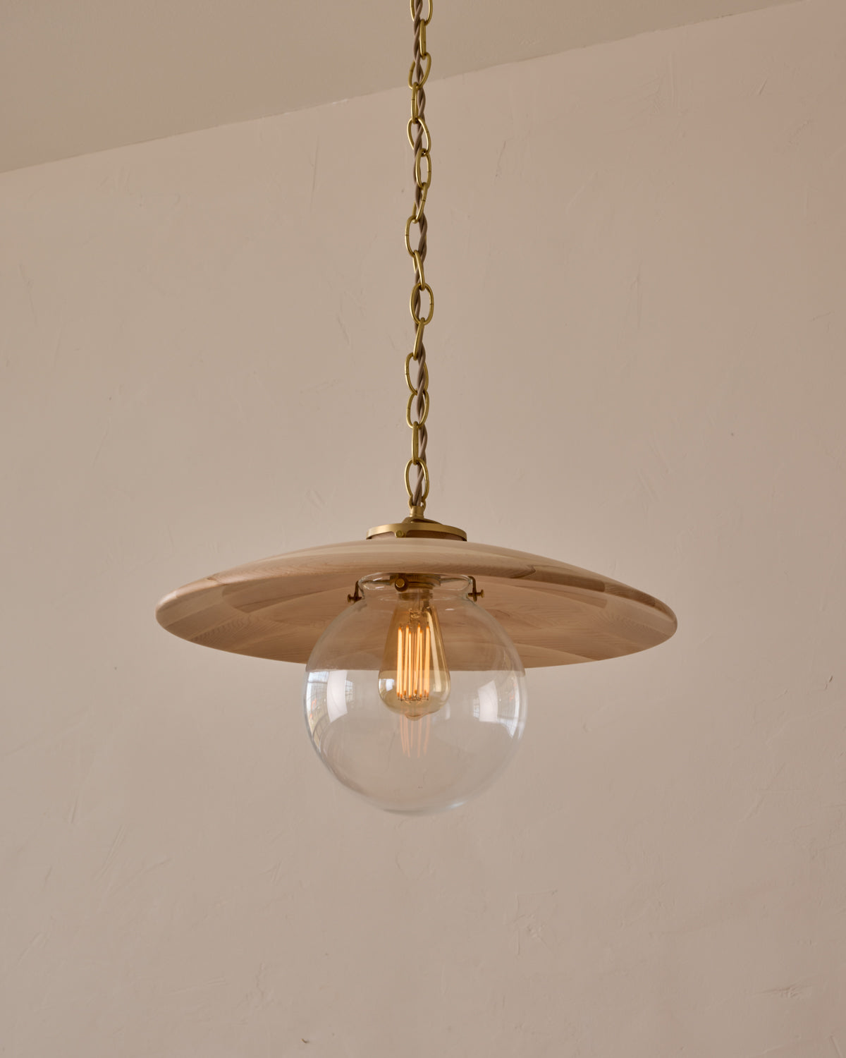 Large pendant light with oversized clear glass globe and decorative wooden clear maple shade with brass chain #shade-finish_clear maple #globe_clear glass #cord-color_beige