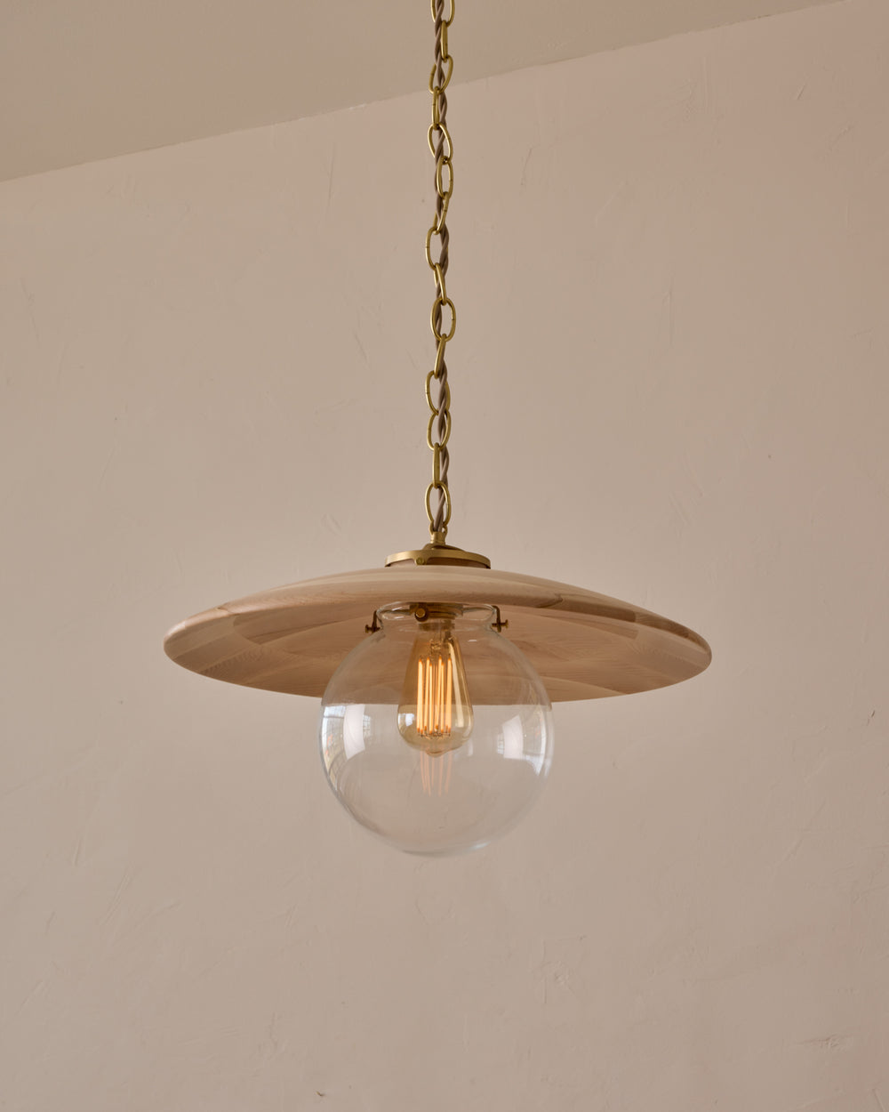 Large pendant light with oversized clear glass globe and decorative wooden clear maple shade with brass chain #shade-finish_clear maple #globe_clear glass #cord-color_beige