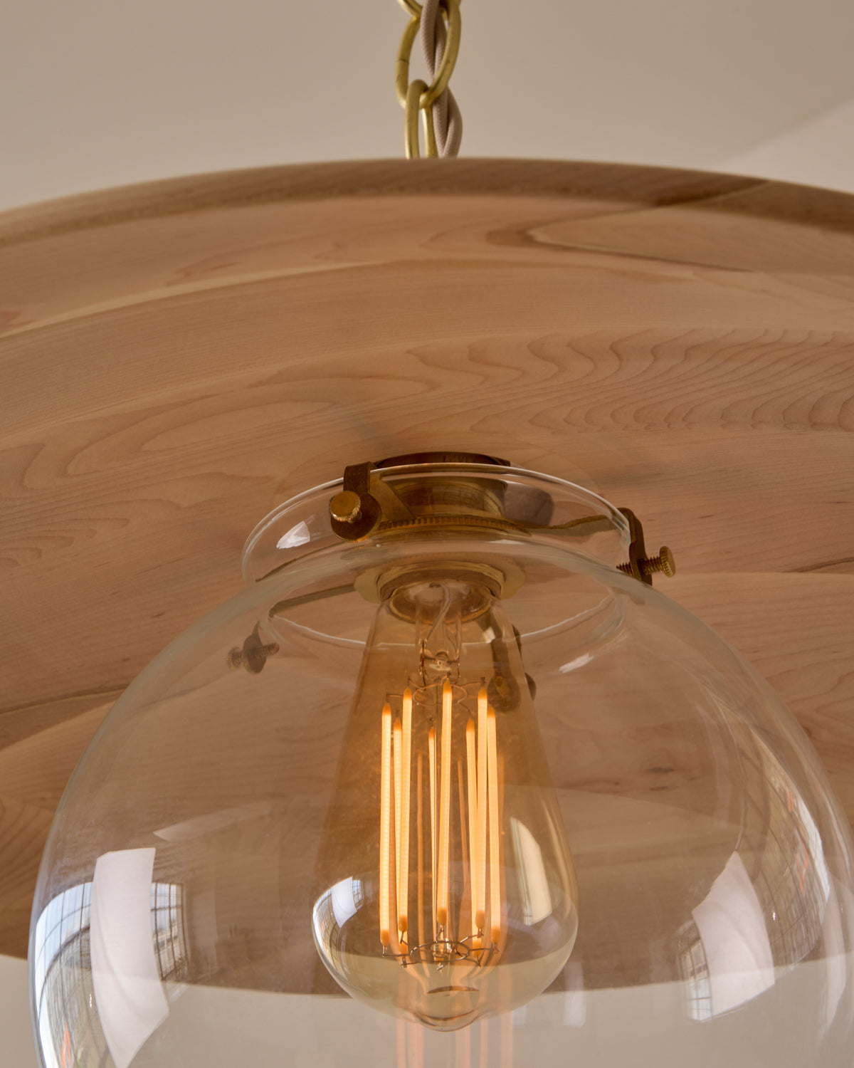 Large pendant light with oversized clear glass globe and decorative wooden clear maple shade with brass chain #shade-finish_clear maple #globe_clear glass #cord-color_beige