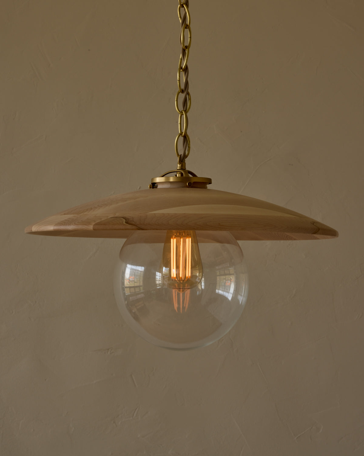 Large pendant light with oversized clear glass globe and decorative wooden clear maple shade with brass chain #shade-finish_clear maple #globe_clear glass #cord-color_beige