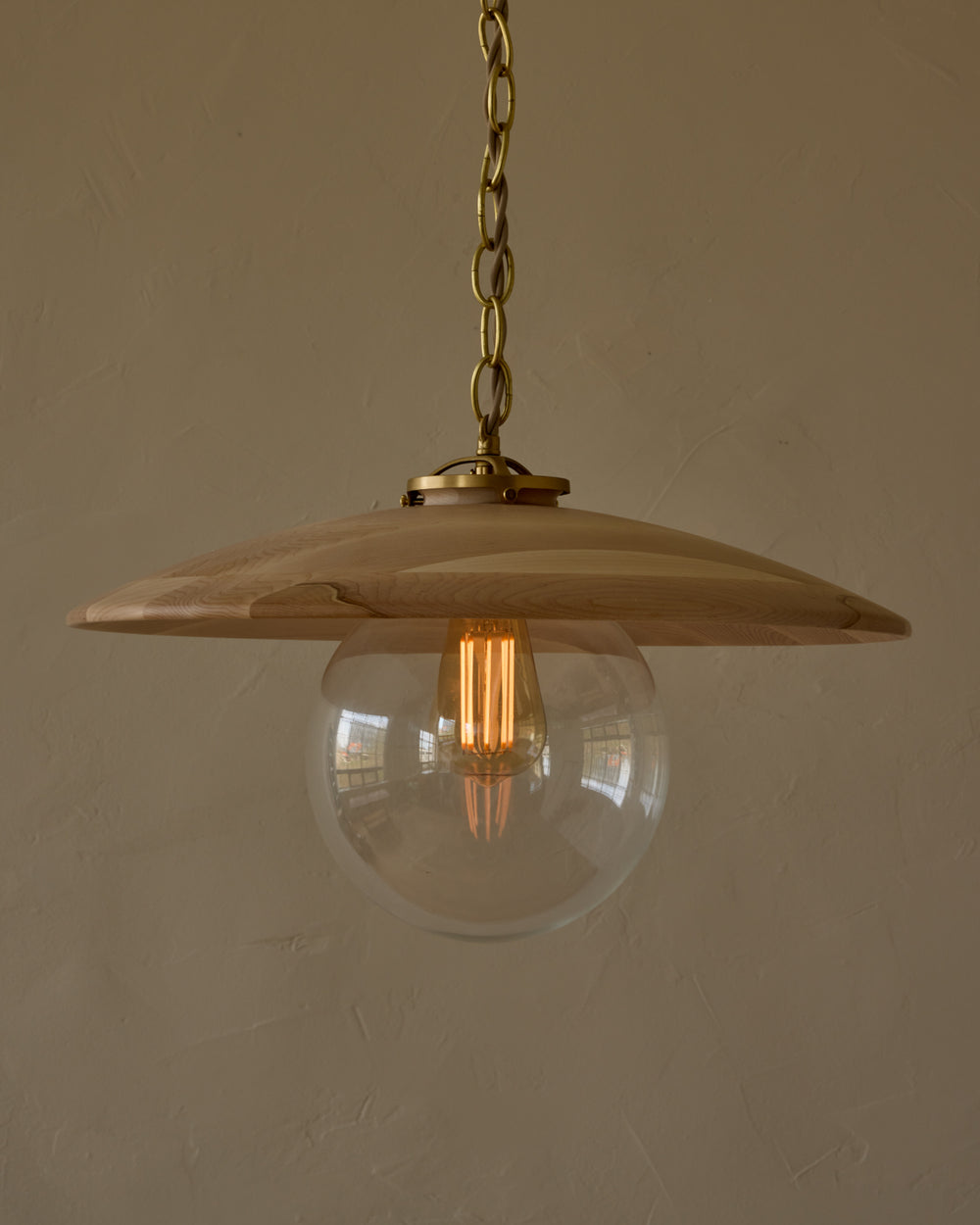 Large pendant light with oversized clear glass globe and decorative wooden clear maple shade with brass chain #shade-finish_clear maple #globe_clear glass #cord-color_beige