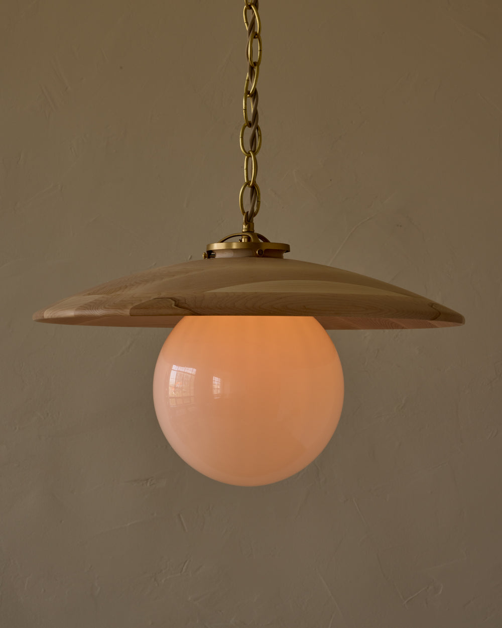 Large pendant light with oversized milk glass globe and decorative wooden clear maple shade with brass chain #shade-finish_clear maple #globe_white glass #cord-color_beige