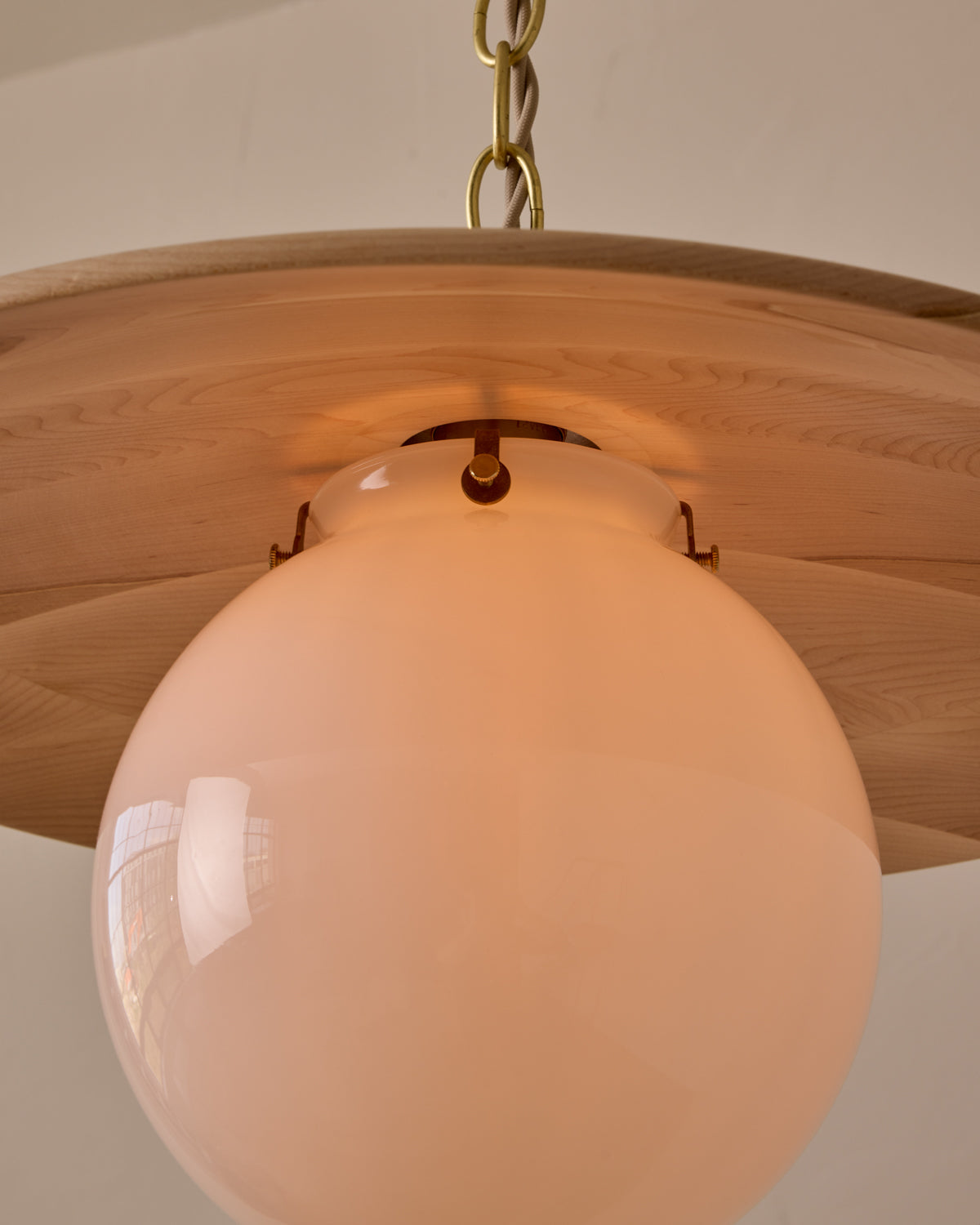 Large pendant light with oversized milk glass globe and decorative wooden clear maple shade with brass chain #shade-finish_clear maple #globe_white glass #cord-color_beige