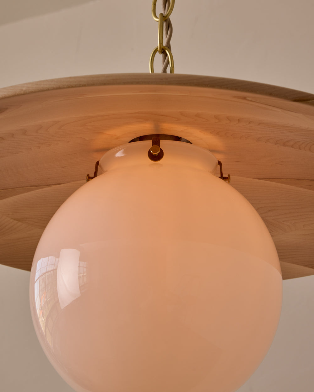Large pendant light with oversized milk glass globe and decorative wooden clear maple shade with brass chain #shade-finish_clear maple #globe_white glass #cord-color_beige