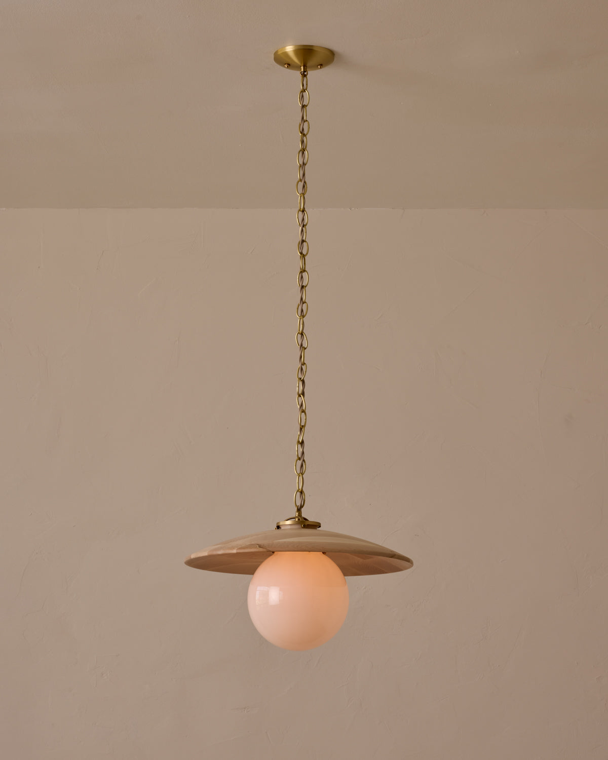 Large pendant light with oversized milk glass globe and decorative wooden clear maple shade with brass chain #shade-finish_clear maple #globe_white glass #cord-color_beige