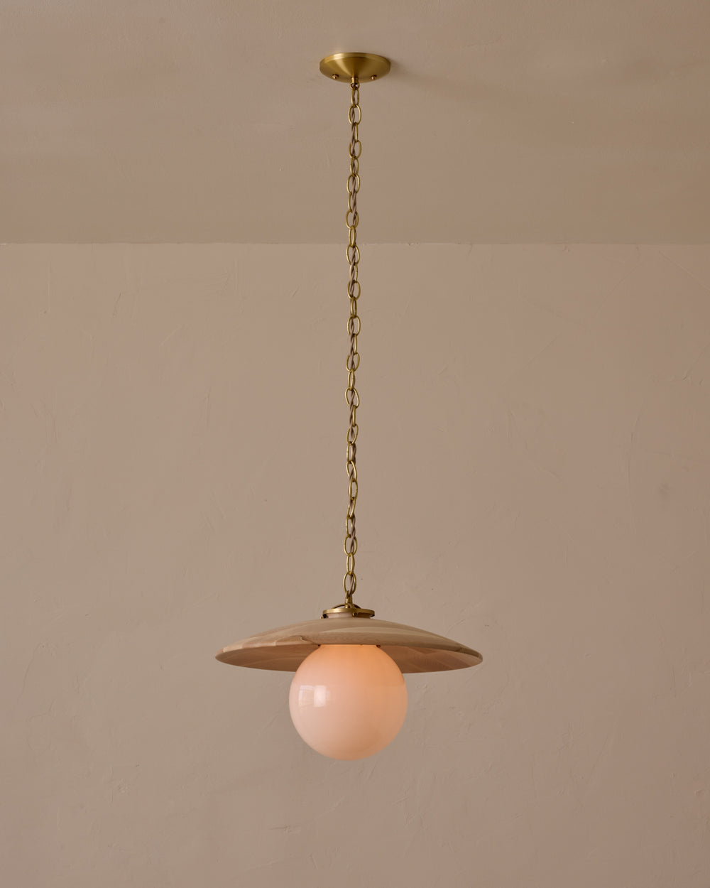 Large pendant light with oversized milk glass globe and decorative wooden clear maple shade with brass chain #shade-finish_clear maple #globe_white glass #cord-color_beige