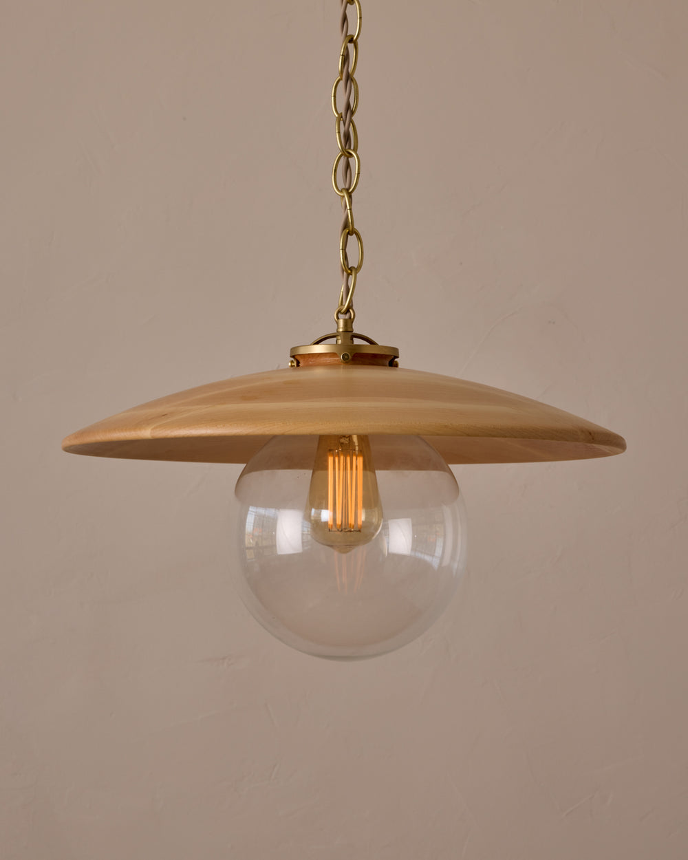 Large pendant light with oversized clear glass globe and decorative wooden clear maple shade with brass chain  #shade-finish_natural maple #globe_clear glass #cord-color_beige