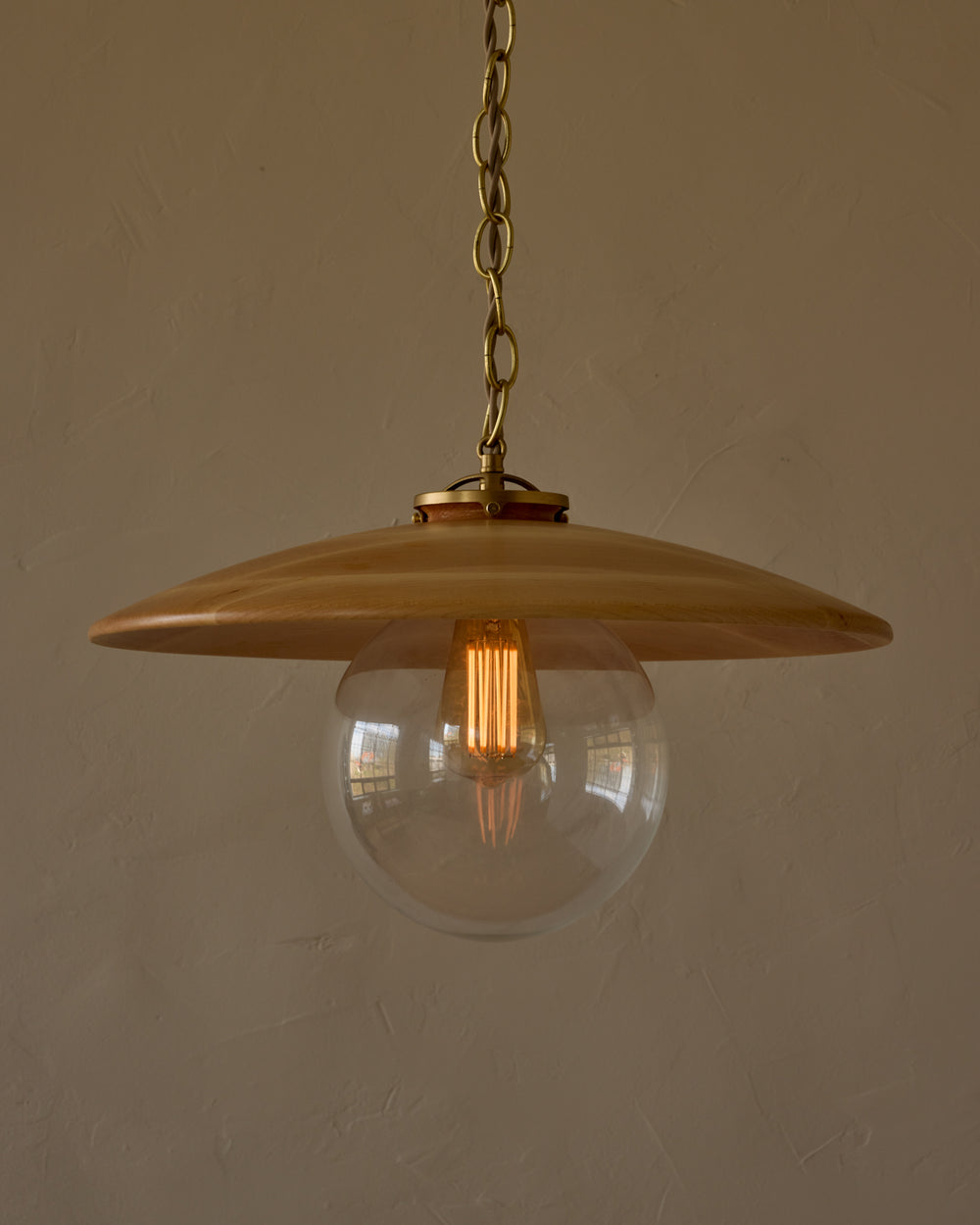 Large pendant light with oversized clear glass globe and decorative wooden clear maple shade with brass chain  #shade-finish_natural maple #globe_clear glass #cord-color_beige