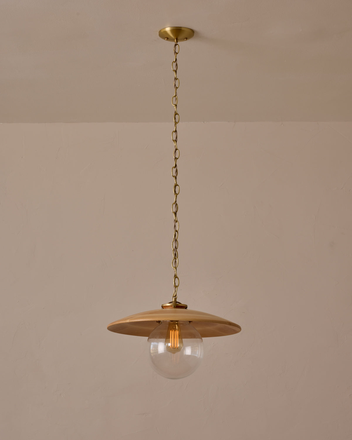 Large pendant light with oversized clear glass globe and decorative wooden clear maple shade with brass chain  #shade-finish_natural maple #globe_clear glass #cord-color_beige