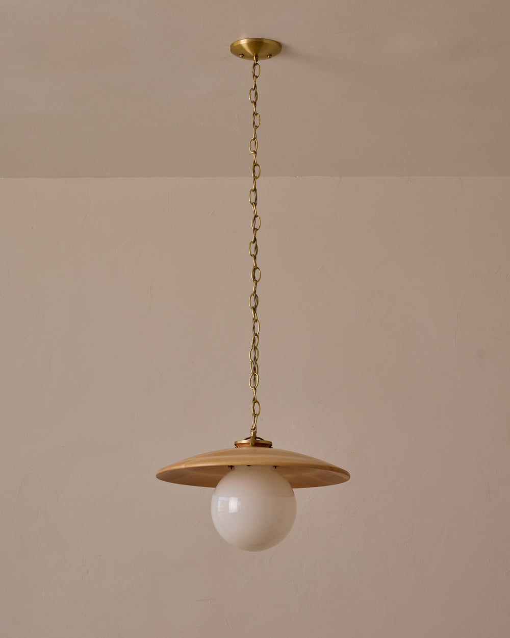 Large pendant light with oversized clear glass globe and decorative wooden clear maple shade with brass chain  #shade-finish_natural maple #globe_white glass #cord-color_beige