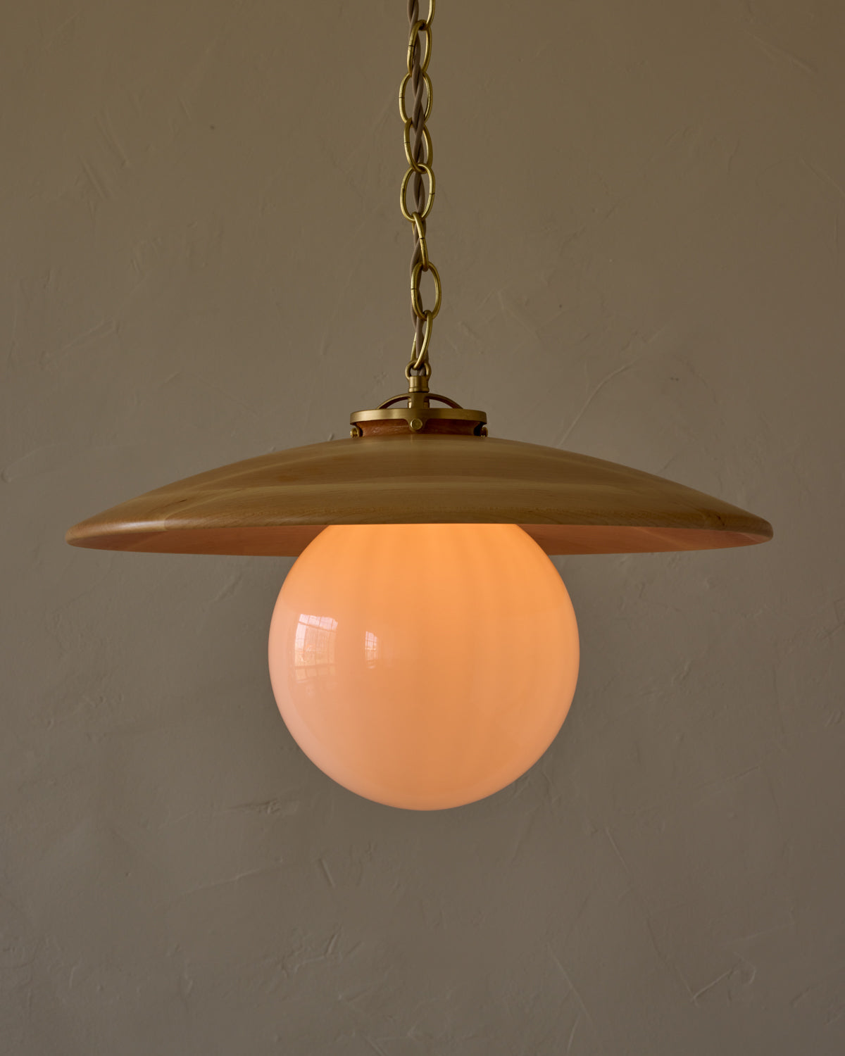 Large pendant light with oversized clear glass globe and decorative wooden clear maple shade with brass chain  #shade-finish_natural maple #globe_white glass #cord-color_beige