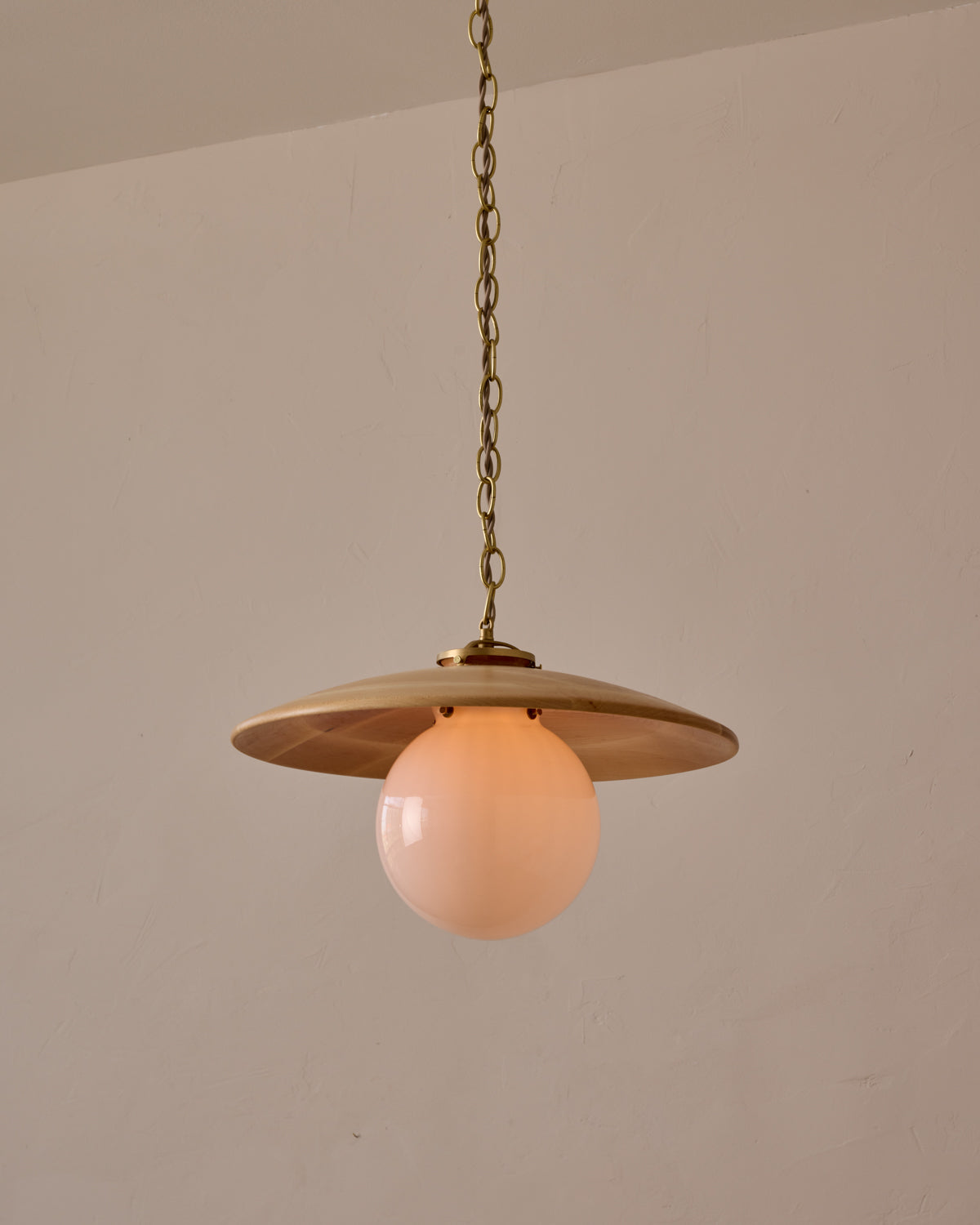 Large pendant light with oversized clear glass globe and decorative wooden clear maple shade with brass chain  #shade-finish_natural maple #globe_white glass #cord-color_beige