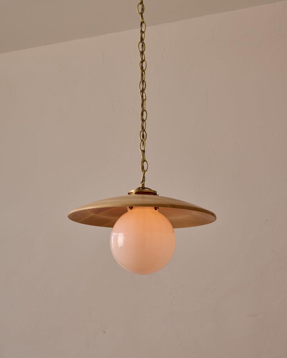 Large pendant light with oversized clear glass globe and decorative wooden clear maple shade with brass chain  #shade-finish_natural maple #globe_white glass #cord-color_beige