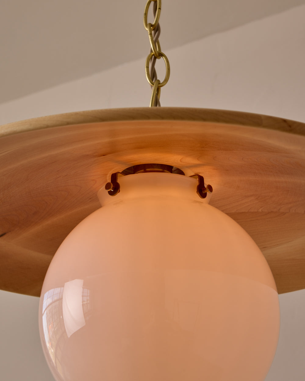 Large pendant light with oversized clear glass globe and decorative wooden clear maple shade with brass chain  #shade-finish_natural maple #globe_white glass #cord-color_beige