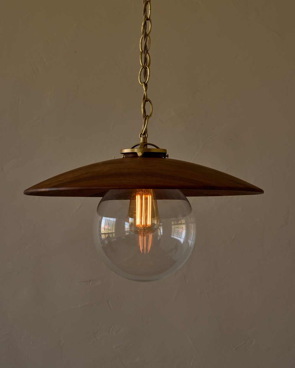 Large pendant light with oversized clear glass globe and decorative wooden clear maple shade with brass chain  #shade-finish_black walnut #globe_clear glass #cord-color_beige