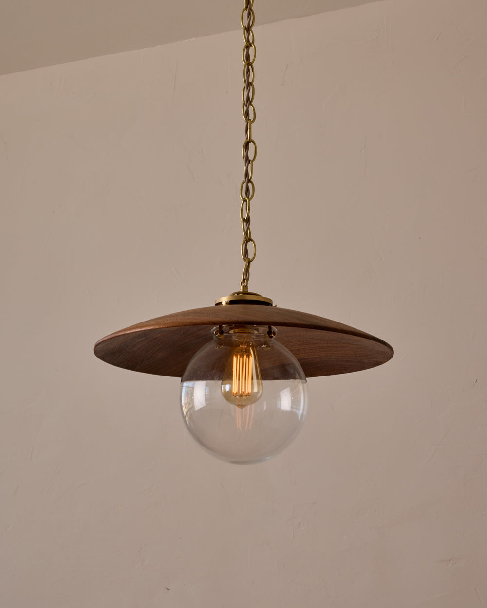 Large pendant light with oversized clear glass globe and decorative wooden clear maple shade with brass chain  #shade-finish_black walnut #globe_clear glass #cord-color_beige