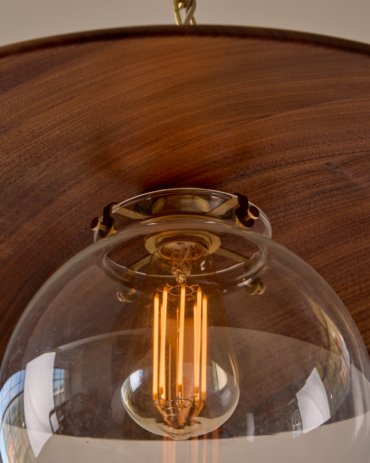 Large pendant light with oversized clear glass globe and decorative wooden clear maple shade with brass chain  #shade-finish_black walnut #globe_clear glass #cord-color_beige