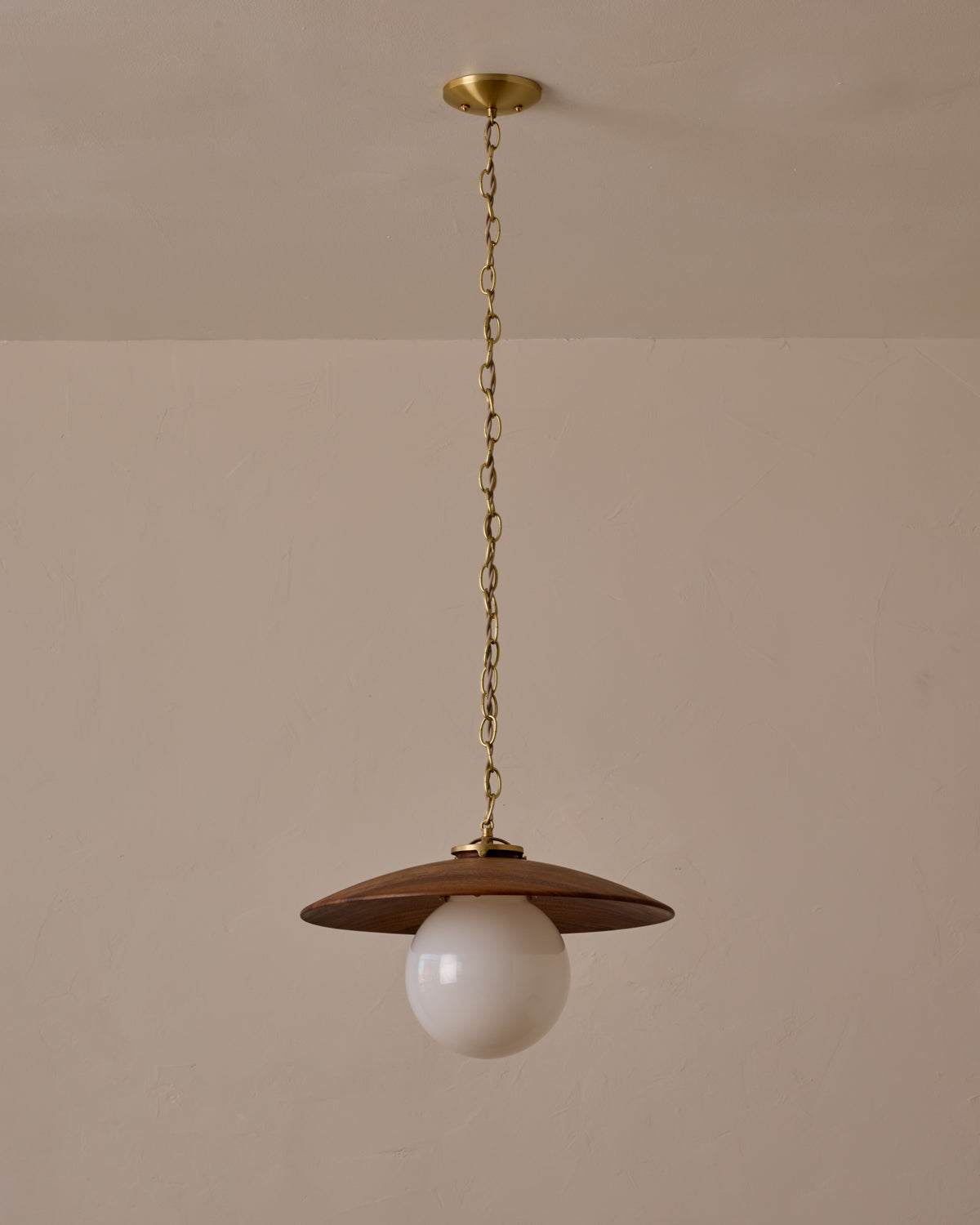 Large pendant light with oversized clear glass globe and decorative wooden clear maple shade with brass chain  #shade-finish_black walnut #globe_white glass #cord-color_beige