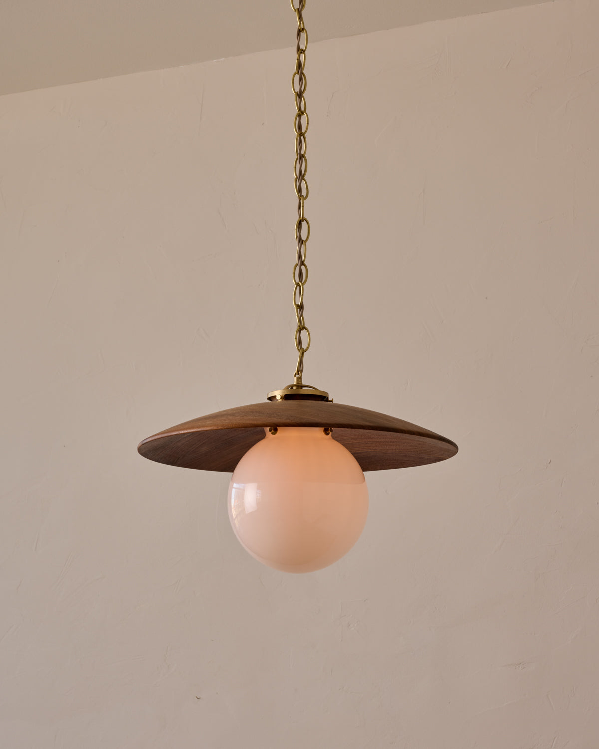 Large pendant light with oversized clear glass globe and decorative wooden clear maple shade with brass chain  #shade-finish_black walnut #globe_white glass #cord-color_beige