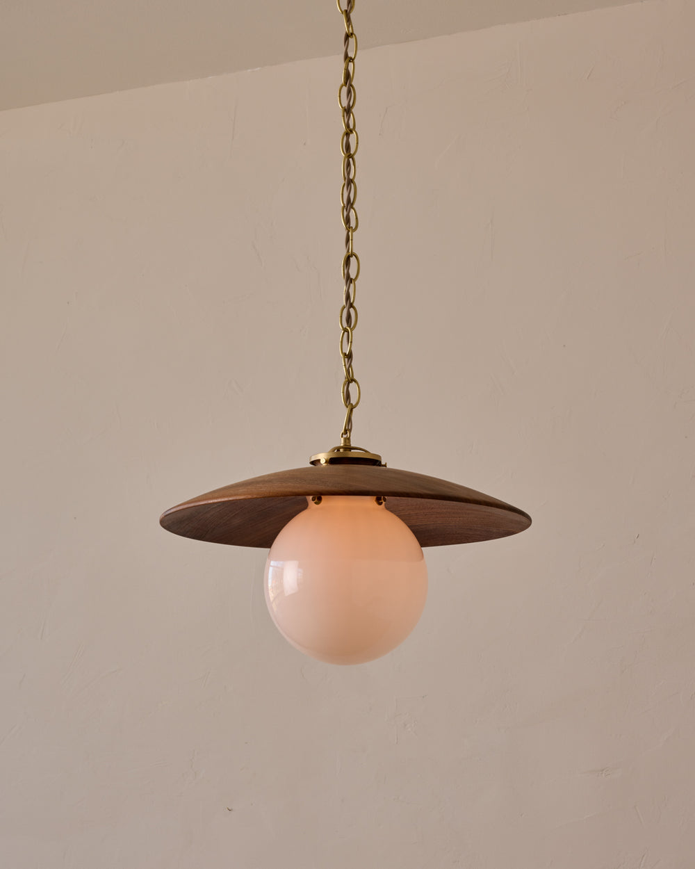 Large pendant light with oversized clear glass globe and decorative wooden clear maple shade with brass chain  #shade-finish_black walnut #globe_white glass #cord-color_beige