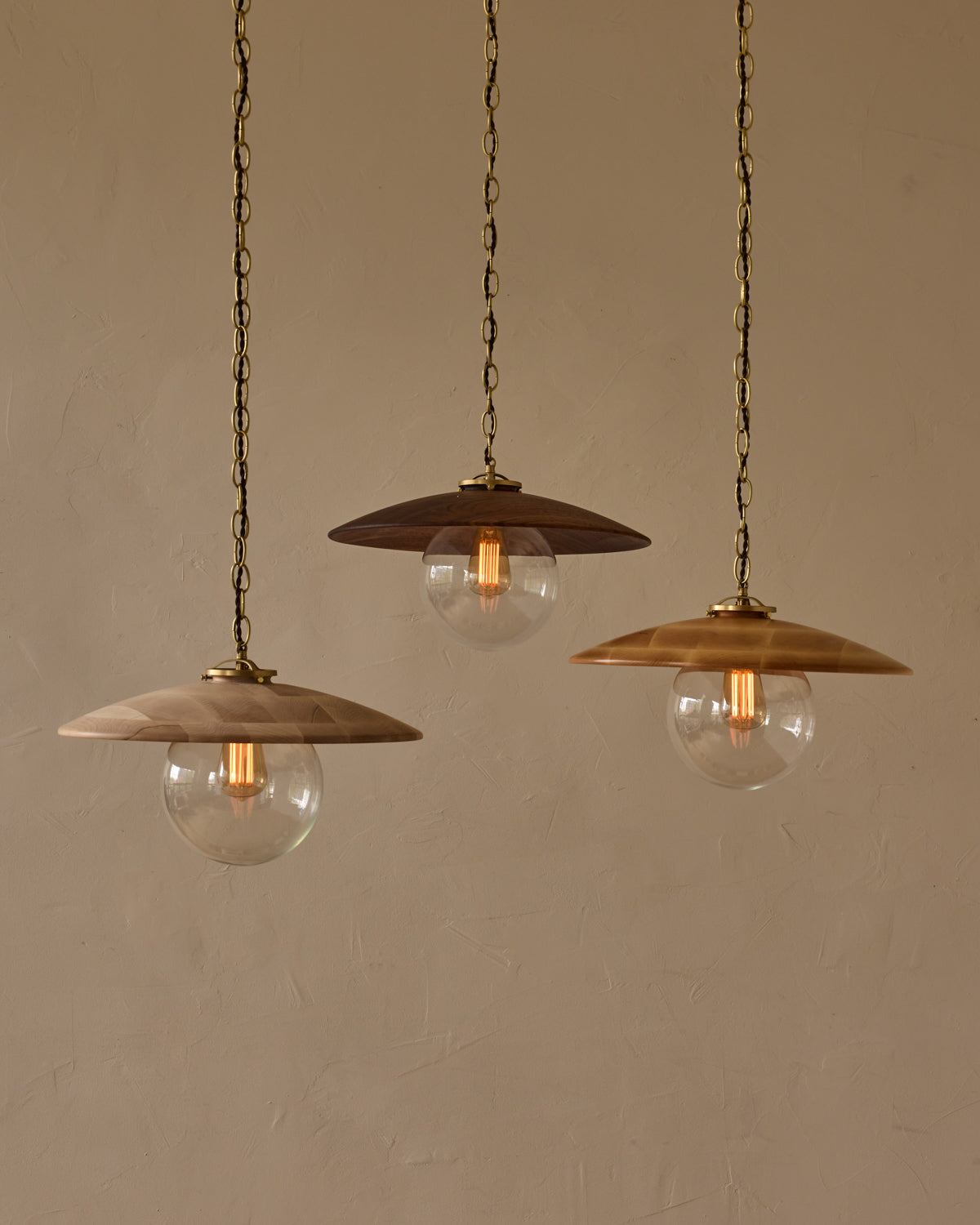 Large pendant light with oversized clear glass globe and decorative wooden clear maple shade with brass chain  #shade-finish_black walnut #globe_clear glass #cord-color_brown