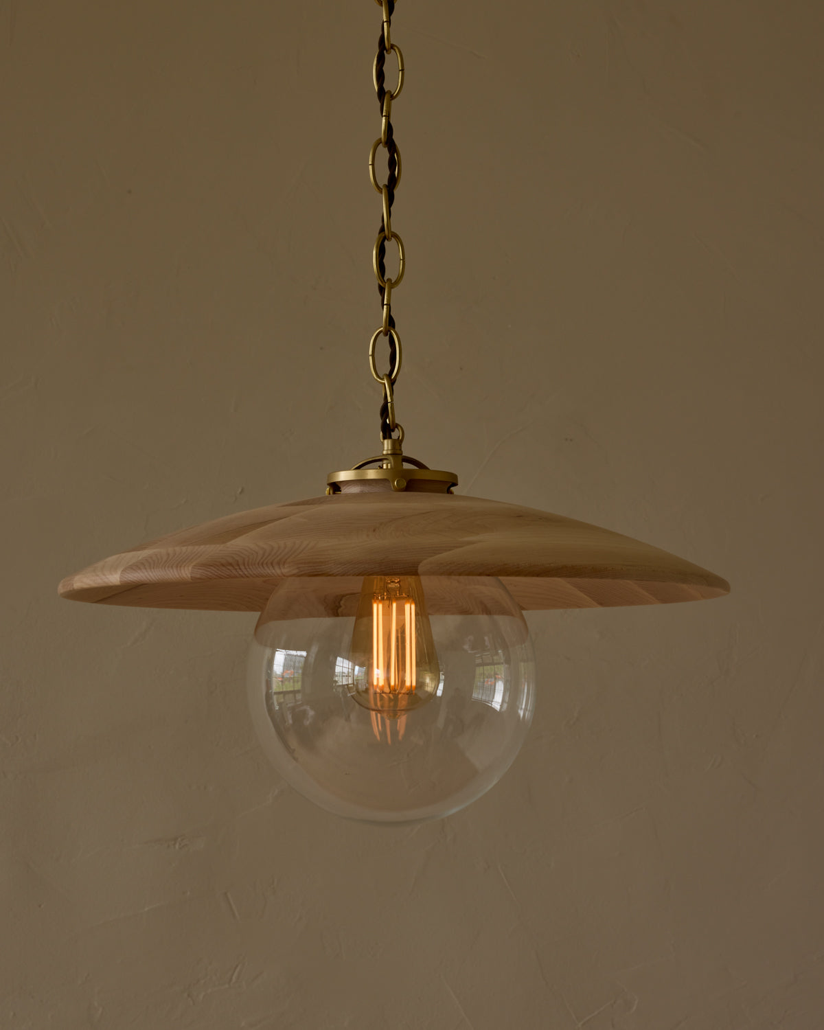 Large pendant light with oversized clear glass globe and decorative wooden clear maple shade with brass chain #shade-finish_clear maple #globe_clear glass #cord-color_brown