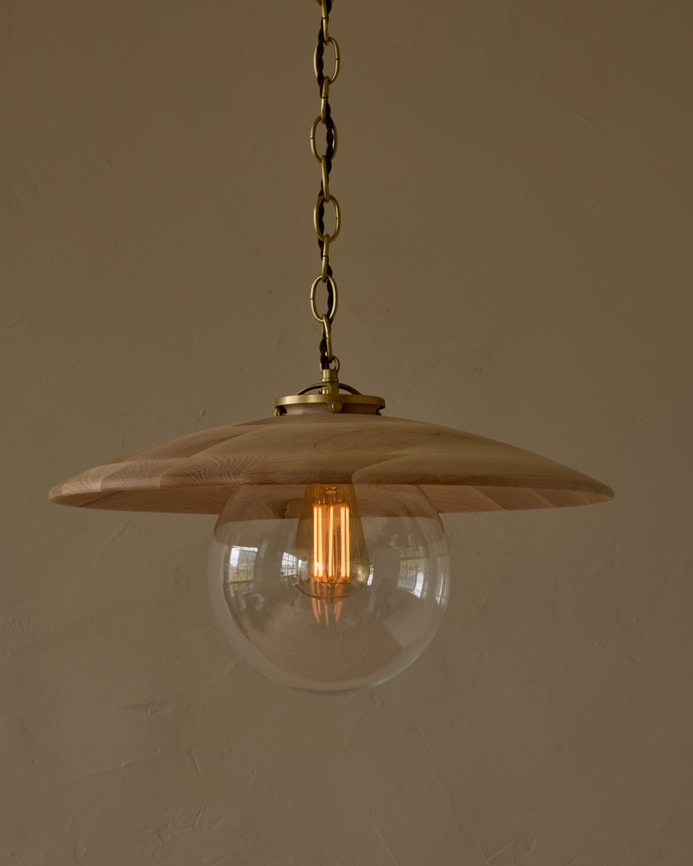Large pendant light with oversized clear glass globe and decorative wooden clear maple shade with brass chain #shade-finish_clear maple #globe_clear glass #cord-color_brown