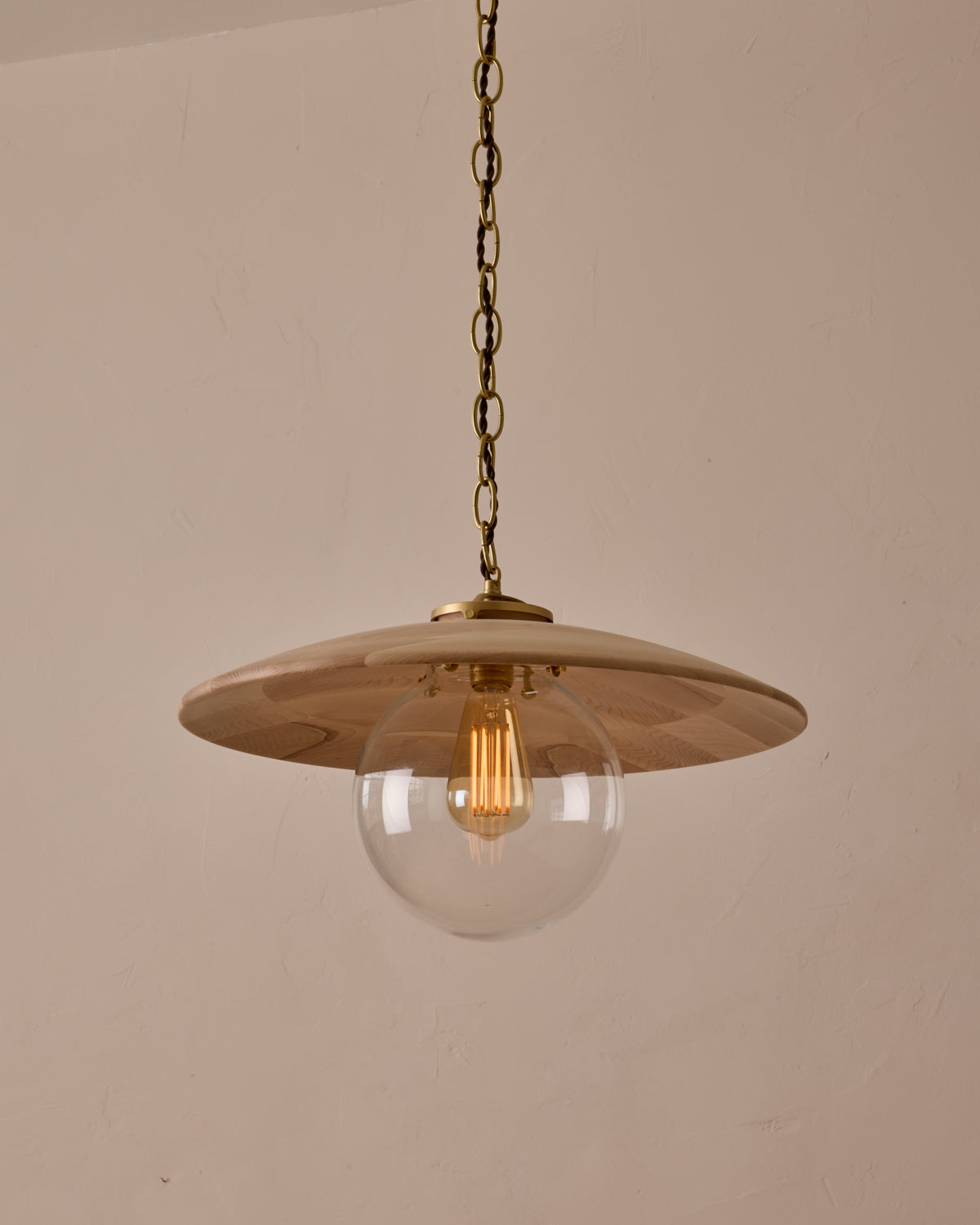 Large pendant light with oversized clear glass globe and decorative wooden clear maple shade with brass chain #shade-finish_clear maple #globe_clear glass #cord-color_brown
