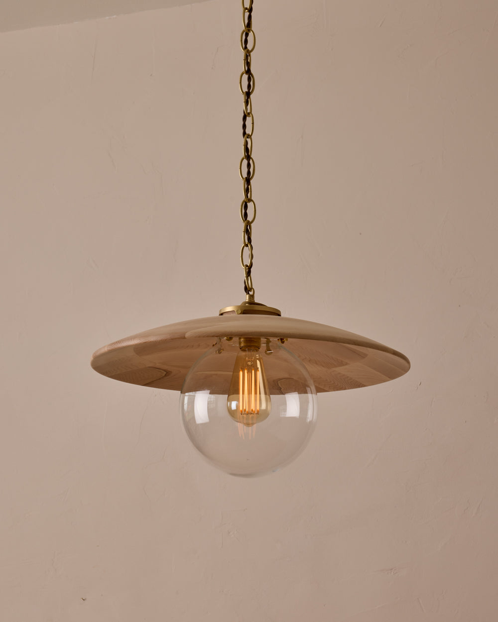 Large pendant light with oversized clear glass globe and decorative wooden clear maple shade with brass chain #shade-finish_clear maple #globe_clear glass #cord-color_brown
