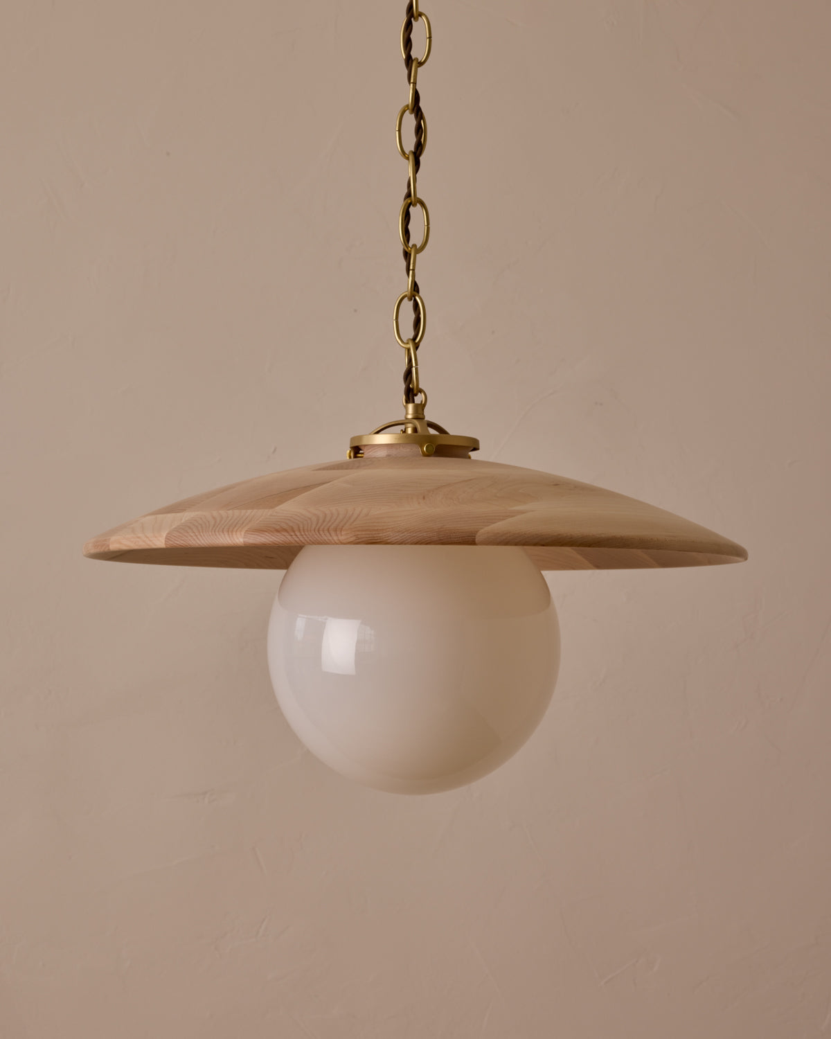 Large pendant light with oversized milk glass globe and decorative wooden clear maple shade with brass chain #shade-finish_clear maple #globe_white glass #cord-color_brown