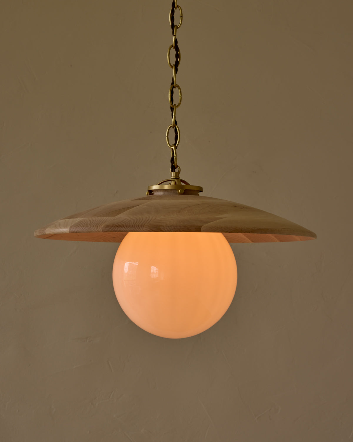 Large pendant light with oversized milk glass globe and decorative wooden clear maple shade with brass chain #shade-finish_clear maple #globe_white glass #cord-color_brown