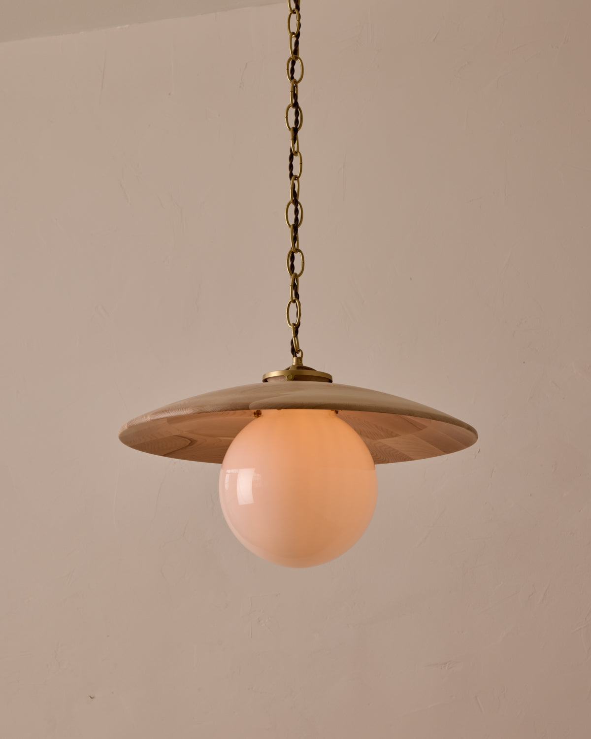 Large pendant light with oversized milk glass globe and decorative wooden clear maple shade with brass chain #shade-finish_clear maple #globe_white glass #cord-color_brown
