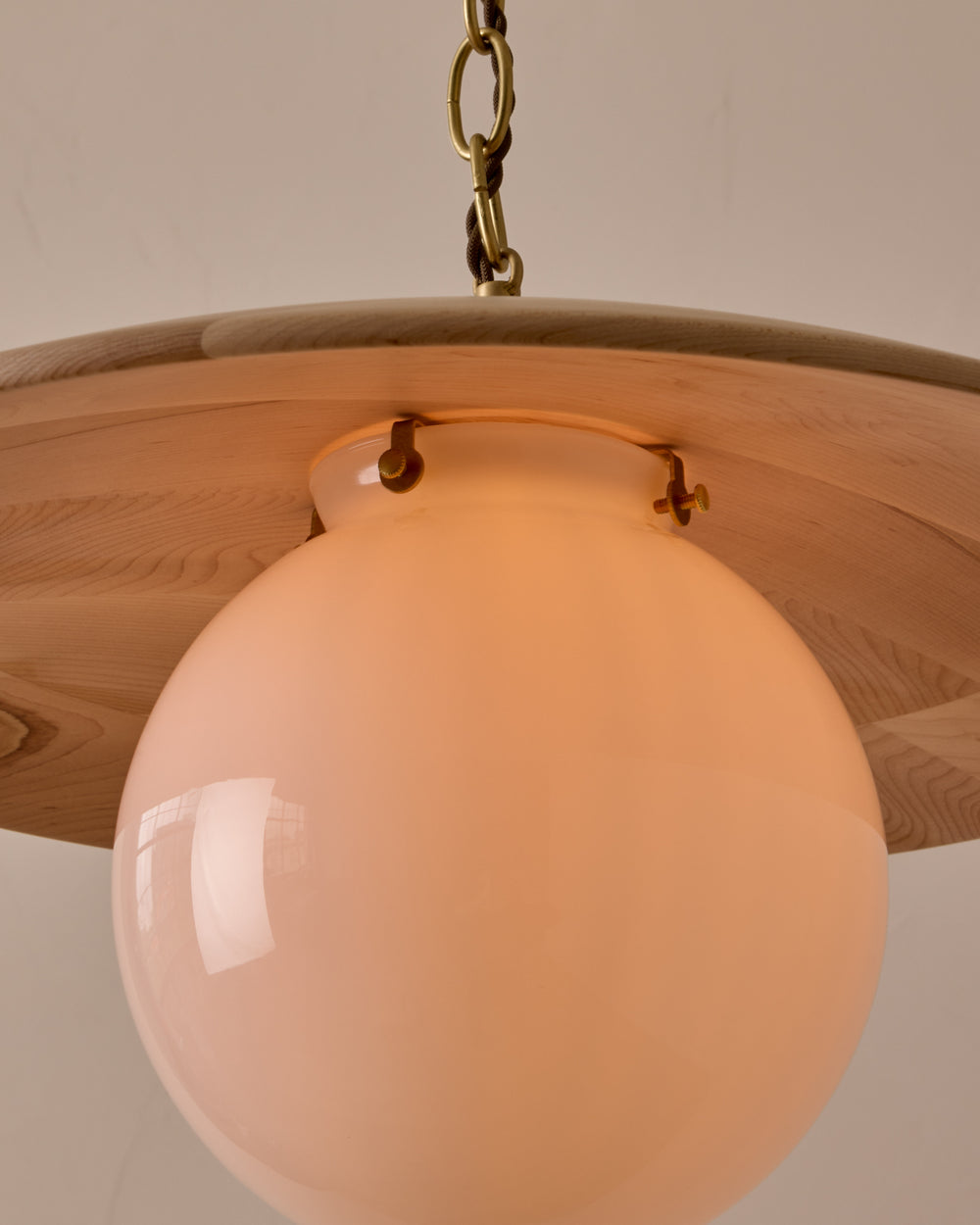 Large pendant light with oversized milk glass globe and decorative wooden clear maple shade with brass chain #shade-finish_clear maple #globe_white glass #cord-color_brown