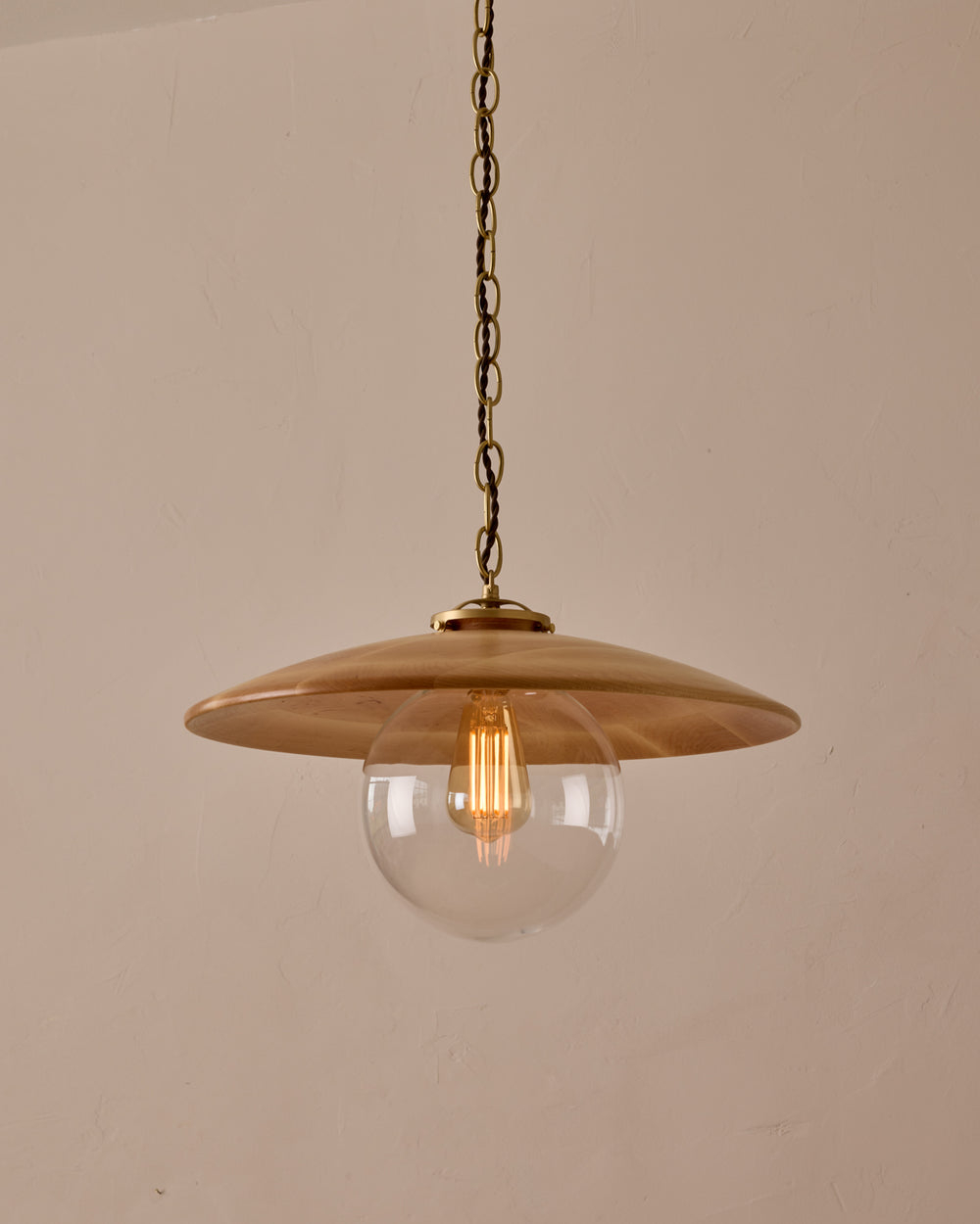 Large pendant light with oversized clear glass globe and decorative wooden clear maple shade with brass chain  #shade-finish_natural maple #globe_clear glass #cord-color_brown