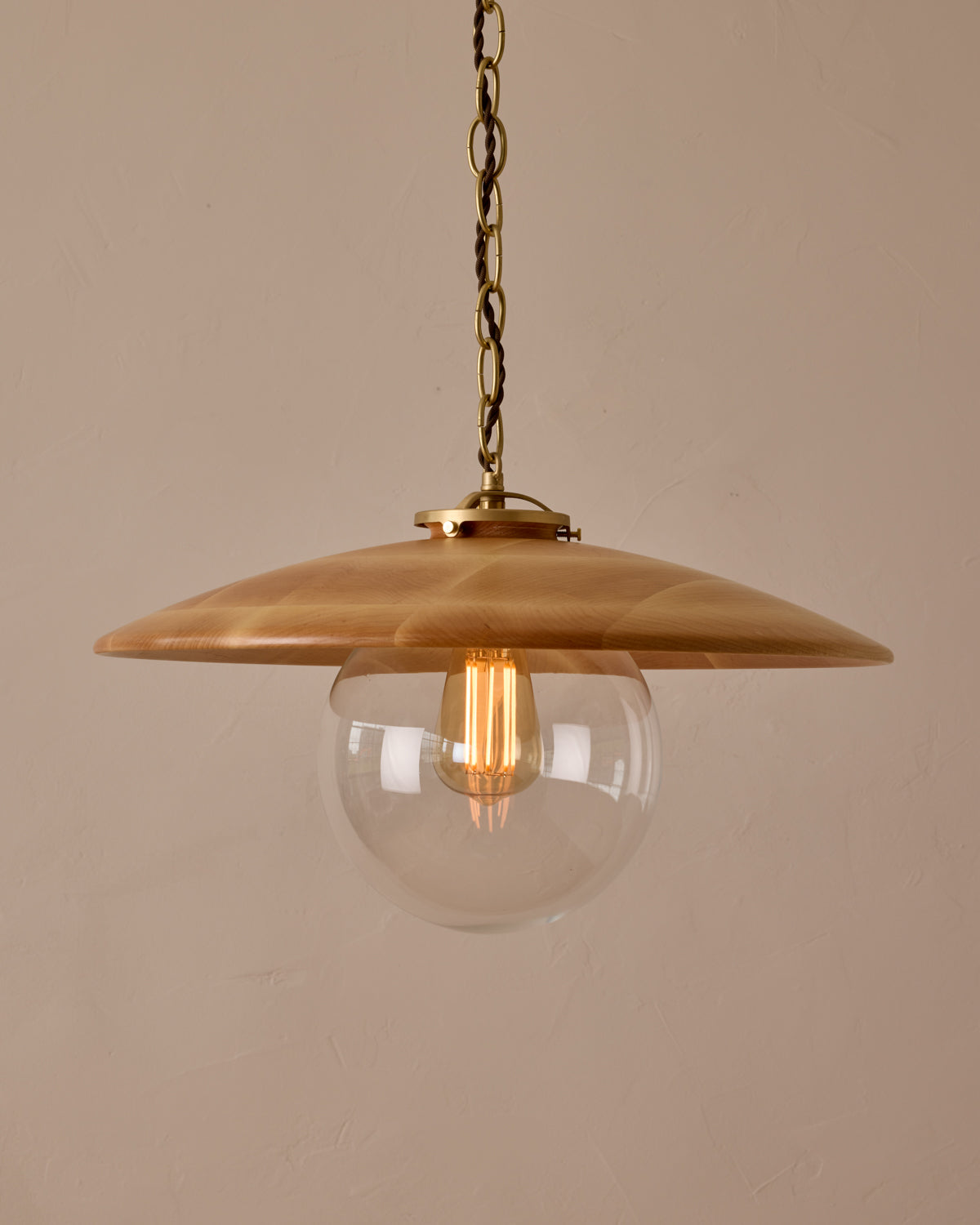 Large pendant light with oversized clear glass globe and decorative wooden clear maple shade with brass chain #shade-finish_natural maple #globe_clear glass #cord-color_brown