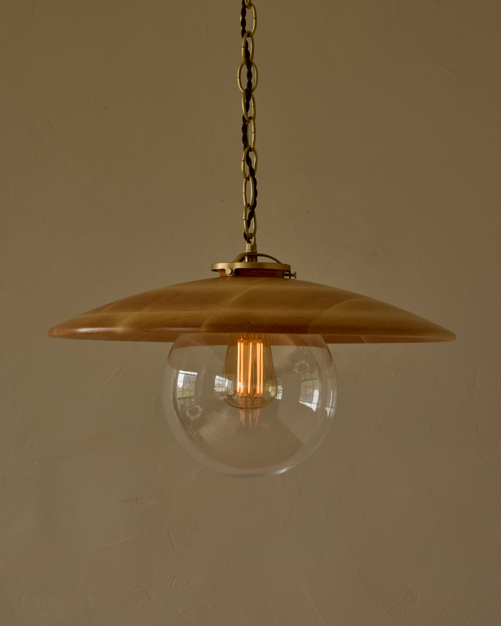 Large pendant light with oversized clear glass globe and decorative wooden clear maple shade with brass chain  #shade-finish_natural maple #globe_clear glass #cord-color_brown